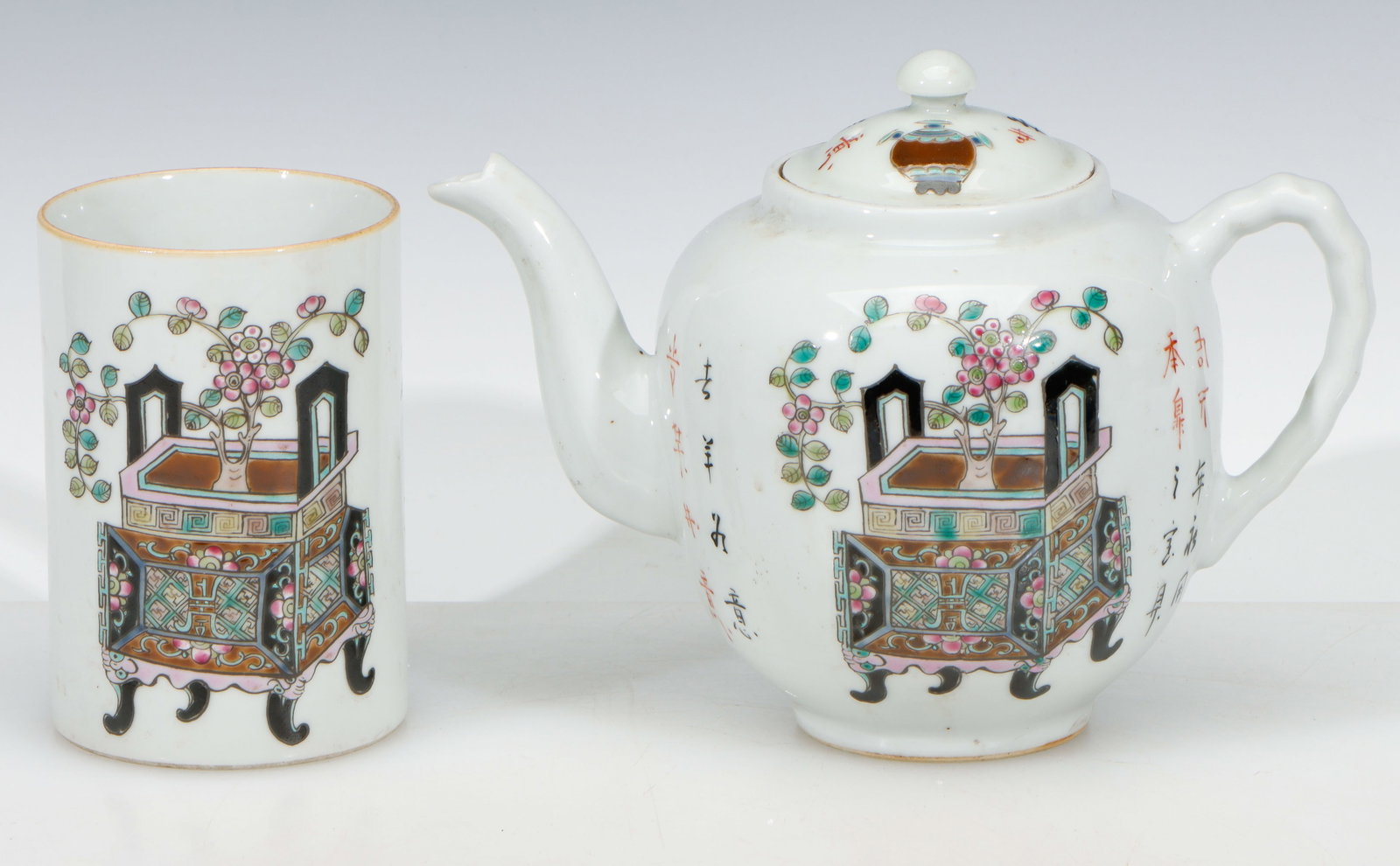 Chinese Famille Rose Brush and Tea Pot: Chinese Famille Rose Brush and Tea Pot. Each depicting a vase with flowers placed within a footed censer; with calligraphy inscriptions on body; and bases marked. Sizes: 1) 4.5'' x 3'' x 3'' (11 x 8 x