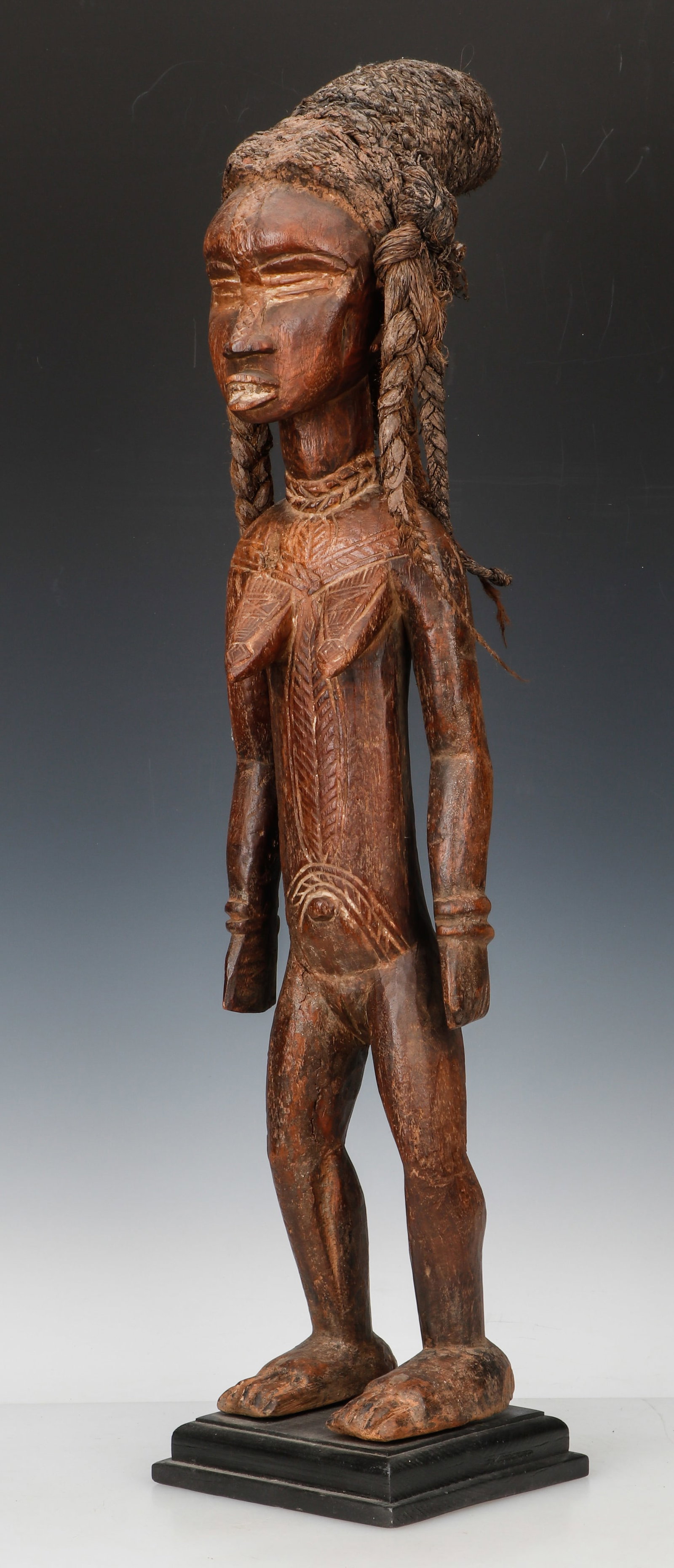 Fine African Dan Female Figure: Fine African Dan Female Figure. Carved wooden female image with linear tribal tattoo designs and a woven grass coiffure. Size: 28'' x 6'' x 10'' (71 x 15 x 25 cm); 1.25'' x 6'' x 10'', 3 x 15 x 25 cm 