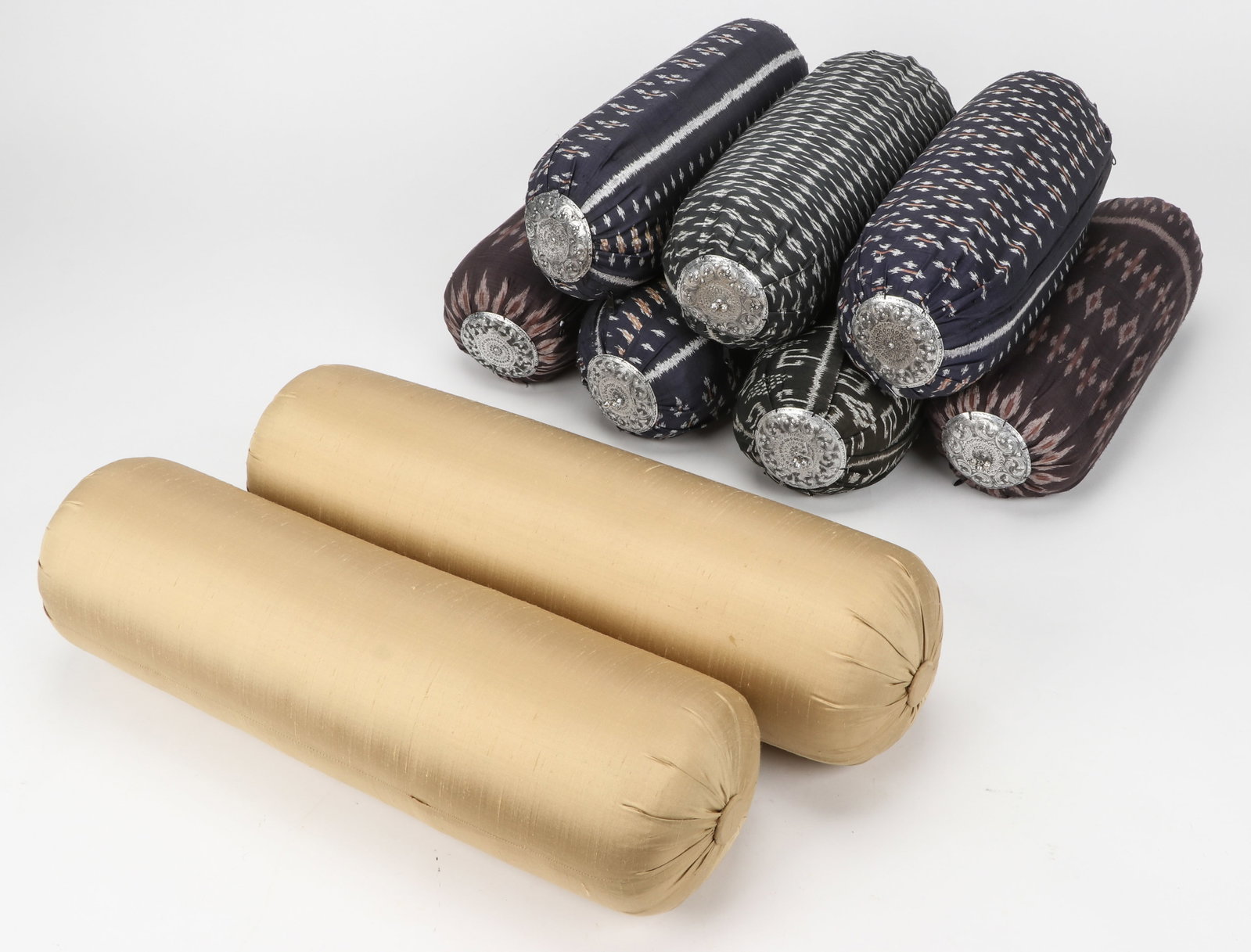Lot of 9 Bolster Pillows: Lot of 9 bolster pillows Size: Ranging From 16'' x 5'' x 5'' (41 x 13 x 13 cm) to 24'' x 7'' x 7'' (61 x 18 x 18 cm).