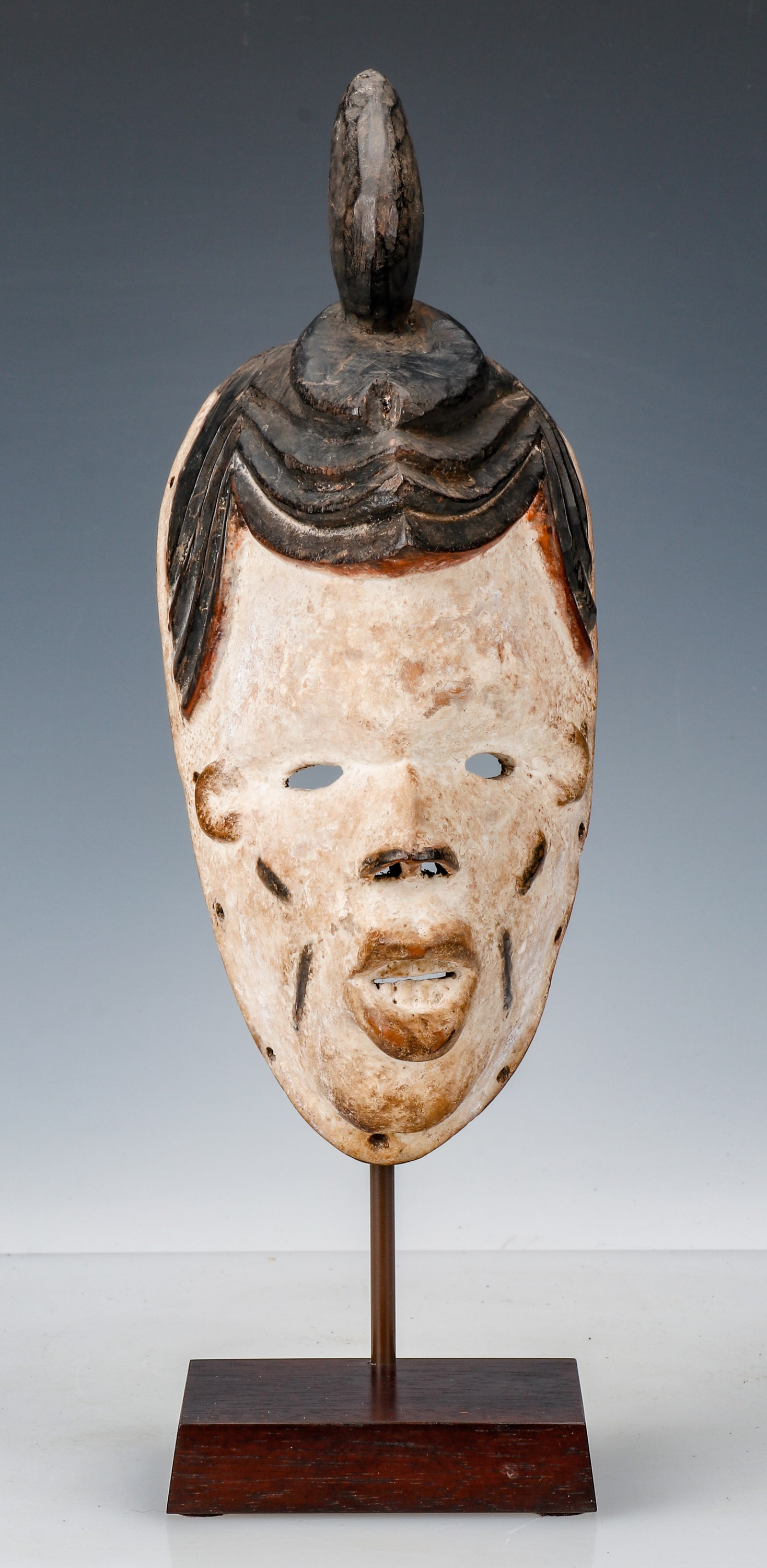 African Okoroshi Mask, Nigeria, Pre 1960's: African Okoroshi Mask, Nigeria. Representing a beautiful young woman, Southeastern Nigeria, this pre 1960 carver’s work is well known. On included stand. Size: 11'' x 4'' x 5'' (28 x 11 x 13 cm); He