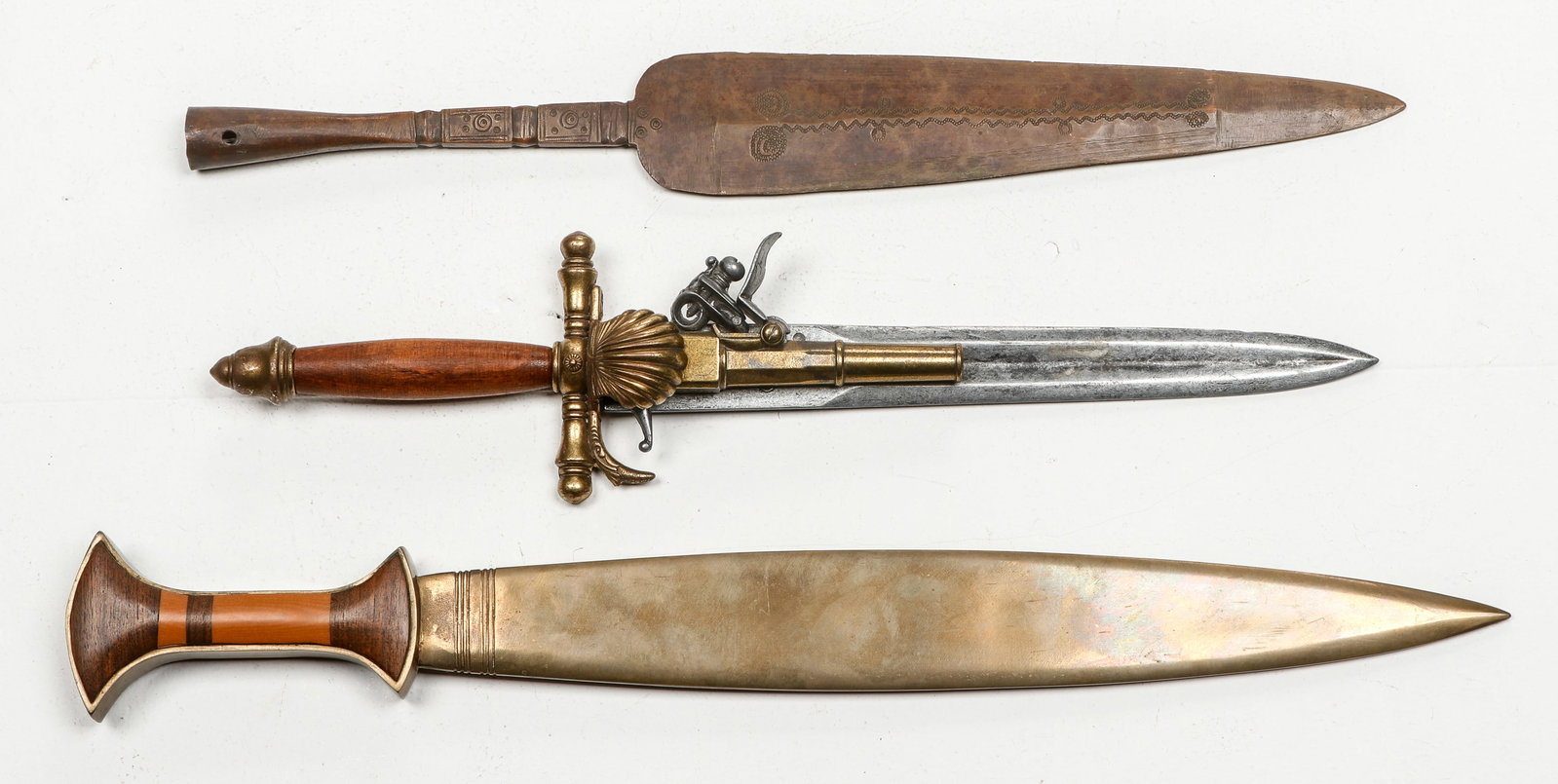Collector's Lot of Weapons: Collector's Lot of Weapons. Including a French 18th Century Style Dagger Pistol Replica, a copper spear point with incised decoration and a long knife. Size: 1) 15'' x 3'' x 2'' (38 x 8 x 5 cm); 2)16'