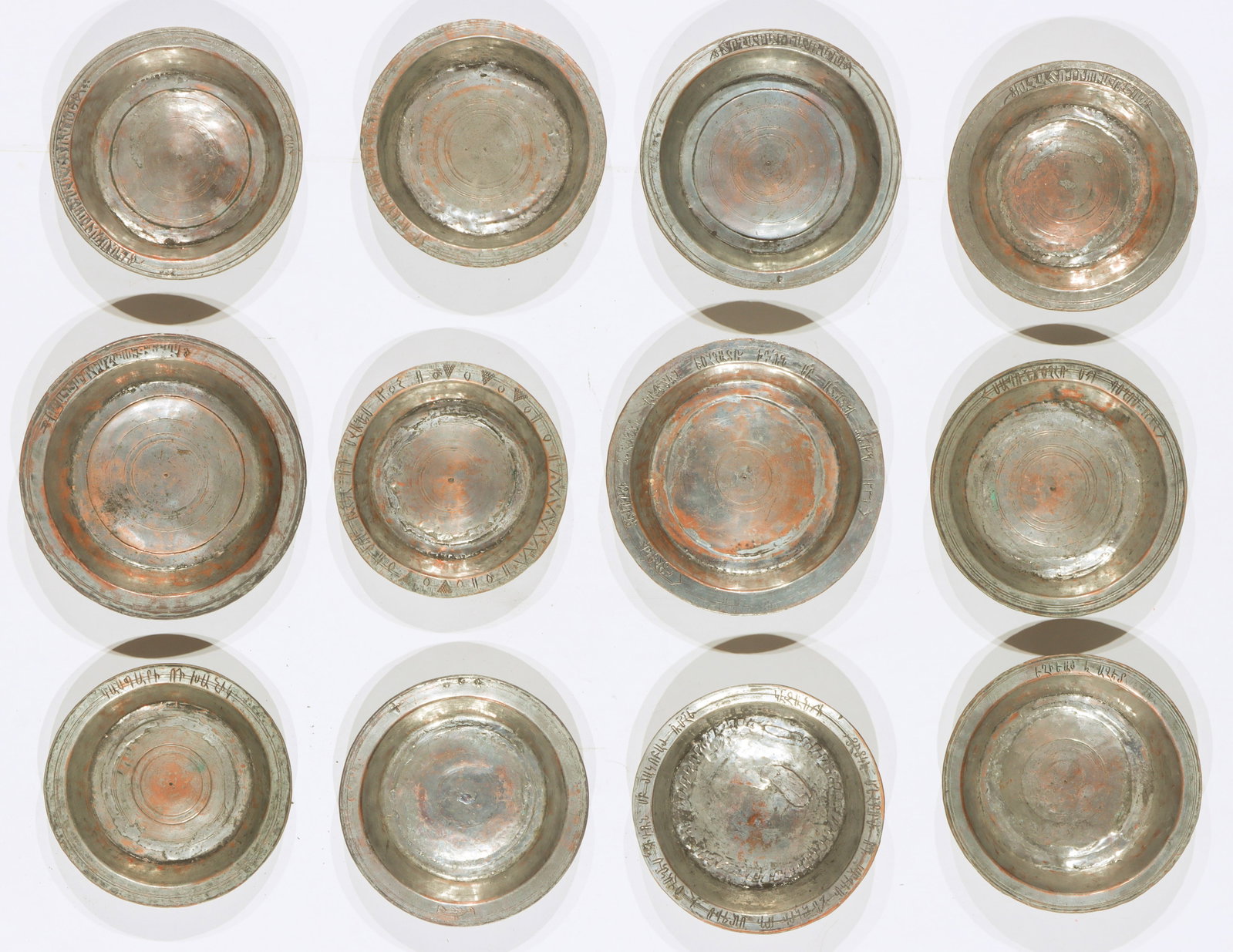 12 Antique Armenian Engraved and Inscribed Tinned Copper Bowls: 12 Antique Armenian Engraved and Inscribed Tinned Copper Bowls. Size: Diameters ranging from: 7" (18 cm) to 8.5" (22 cm). Total weight: 11 lbs.