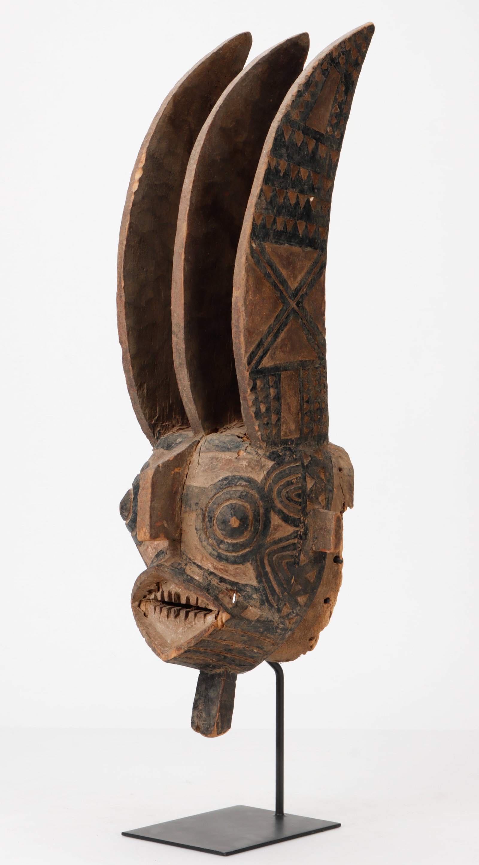 Monumental Winiama Triple Crested Mask, Burkina Faso, H: 32": Monumental Winiama Triple Crested Mask, Burkina Faso. On custom stand. Wood, natural pigments. Size: 32'' x 11'' x 10'' (81 x 28 x 25 cm). Height on stand: 36" (91 cm). The sole, triple bladed Keduneh