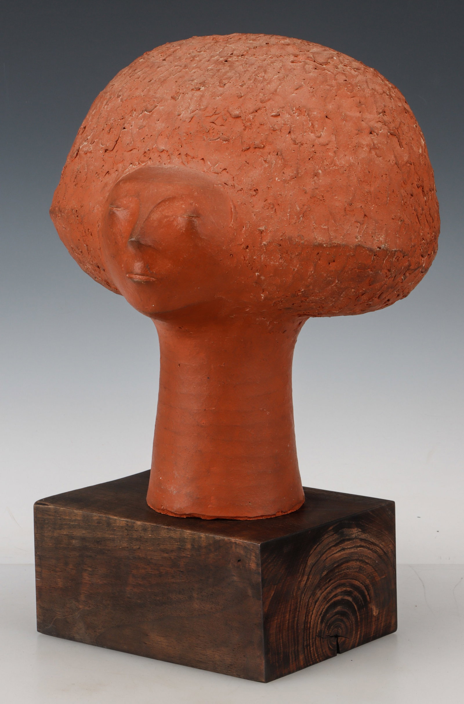 Larry Elsner (American, 1930-1990) Bust of Woman: Larry Elsner (American, 1930-1990) Bust of Woman, c. 1970s, terracotta, on artist's wood base, impressed artist's cypher. Size: 16'' x 9.5'' x 9'' (41 x 24 x 23 cm) (overall, including base). Provenan