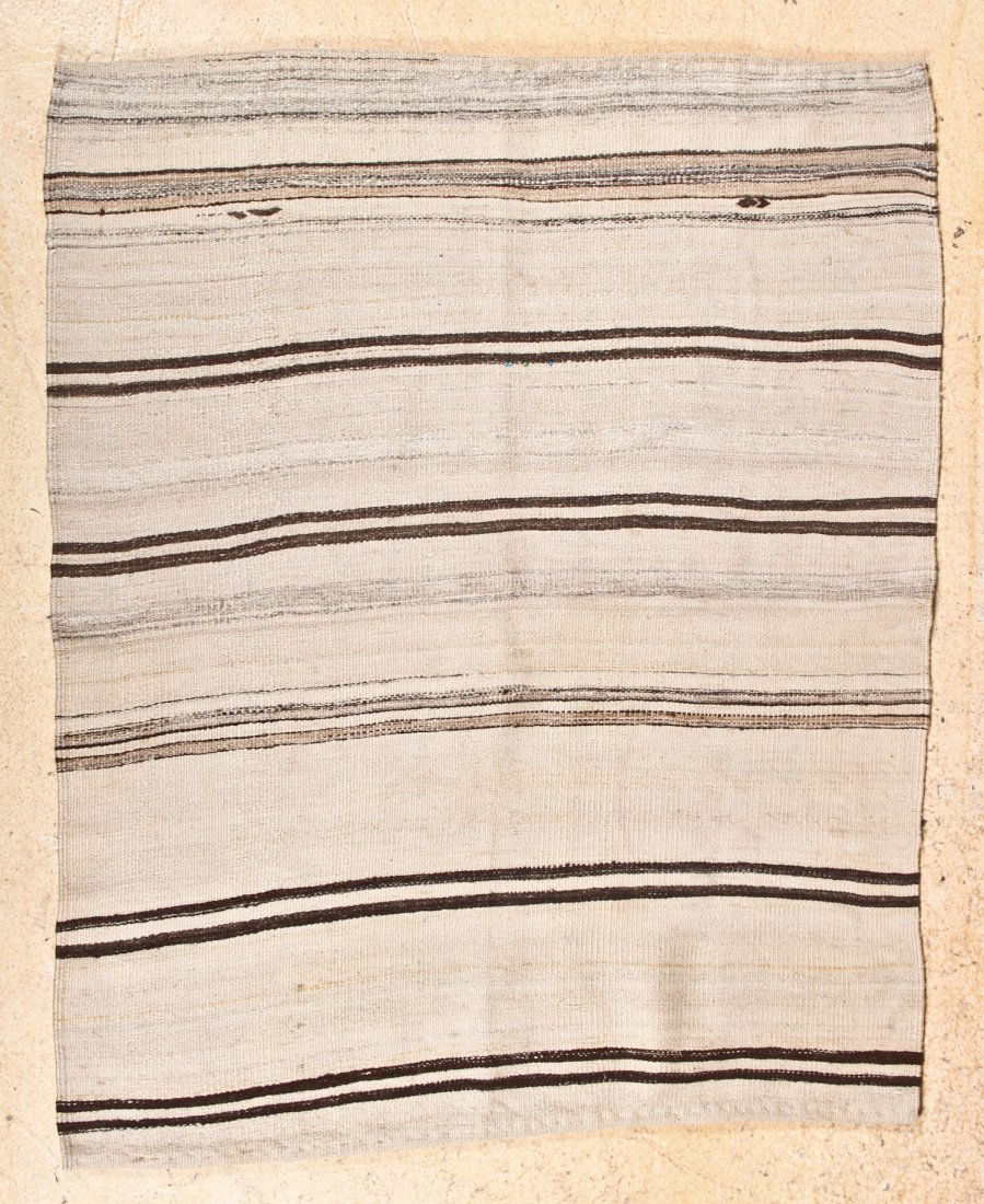 Kurdish Kilim: Kurdish Kilim, eastern Turkey, early 20th c, undyed shades of natural hand-spun sheep wool and goat hair, with a sewn "good luck" bead. Size: 5' x 4'. Cost for us to pack and ship this item via UPS GR