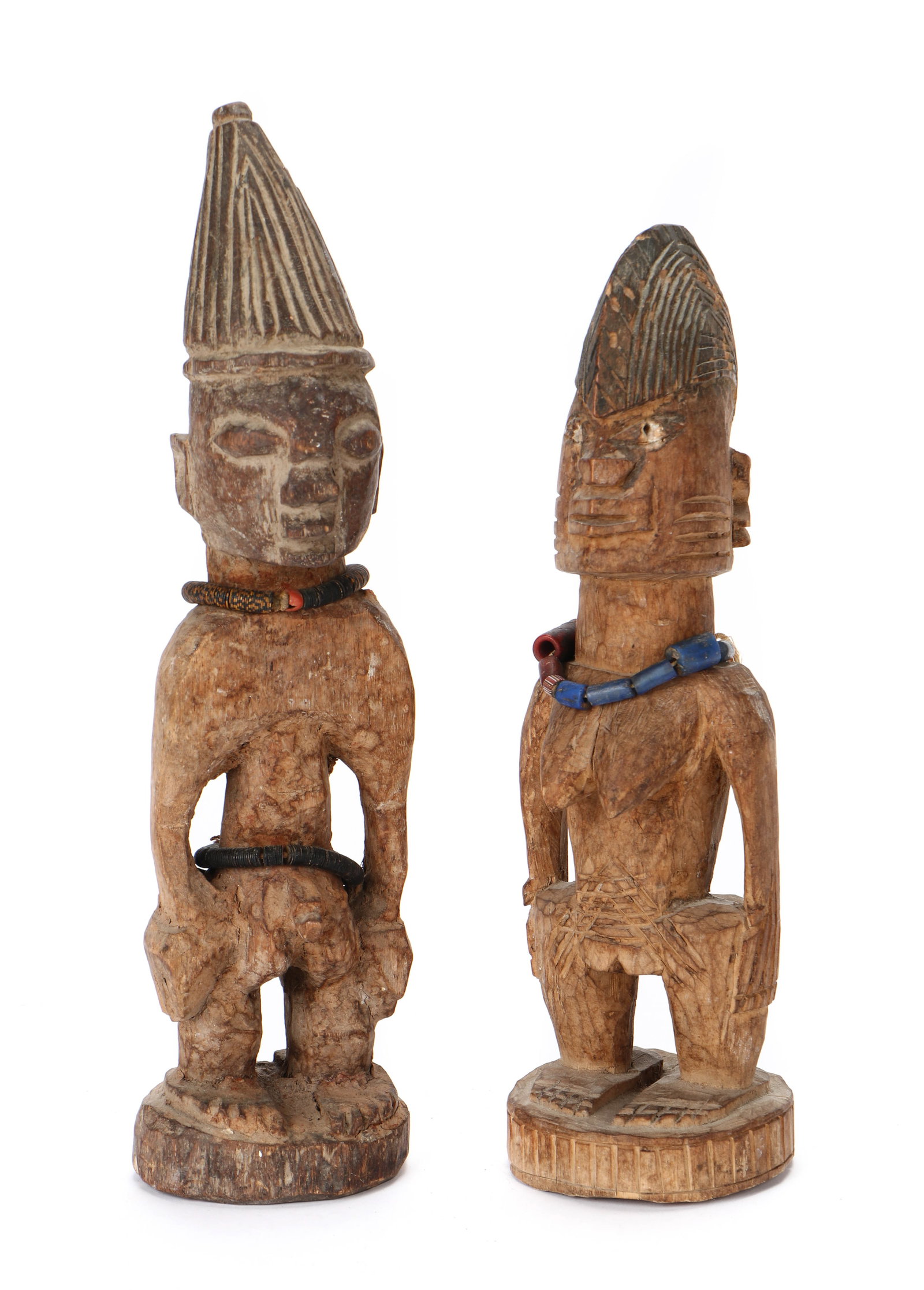 Pair of African Yoruba Ibeji Figures, Nigeria: Pair of African Yoruba Ibeji Figures, Nigeria. Sizes: 1) 11'' x 3'' x 2.5'' (28 x 8 x 6 cm); 2) 9.75'' x 3'' x 3'' (25 x 8 x 8 cm).