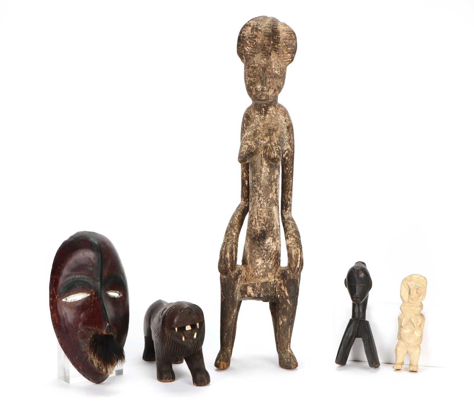 Ethnographic Collector's Lot: Multicultural Ethnographic Group of African Artifacts. Including: a Dan mask with animal fur, Guro carved wood seated female figure, carved bone female figure, and a Guro heddle pulley. Ranging in Siz