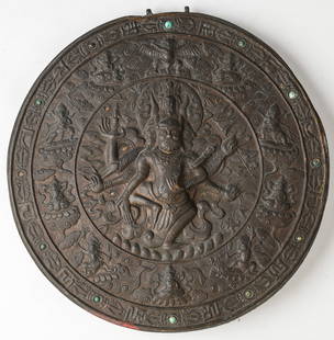 Antique Tibetan Votive Temple Plaque: Antique Tibetan Votive Temple Plaque. High relief copper. Of circular form, the central medallion a multi-headed, six-armed wrathful deity, standing on one foot, his radiating arms holding various