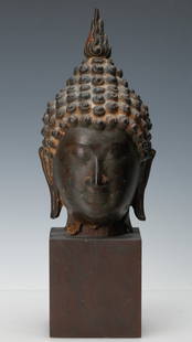 Antique Southeast Asian Bronze Head of Buddha: Antique Southeast Asian Bronze Head of Buddha. Size: 13.5'' x 4.5'' x 5'' (34 x 11 x 13 cm). Provenance: Collection of Dr. and Mrs. Albert and Carol Rosenthal/Estate of Carol Rosenthal.
