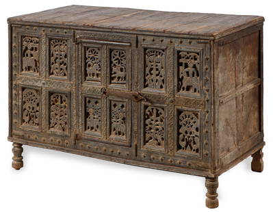 Antique Indian/India Heavily Carved Rajasthan Wood Trunk: Antique Indian/India Heavily Carved Rajasthan Wood Trunk. Early 20th Century. The decorative 10 panel front with figures, animal and floral designs. With front door to reveal interior storage. Size: 3