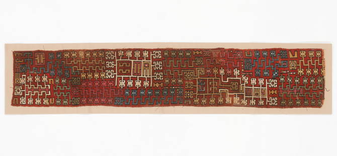 Mantle Border Fragment, Nazca Valley, South Coast, c. 400-600 CE: Mantle Border Fragment, Nazca Valley, South Coast, c. 400-600 CE. Featuring multicolored strand designs and repetitive head motifs on a red background, it reflects key symbolic forms understood by