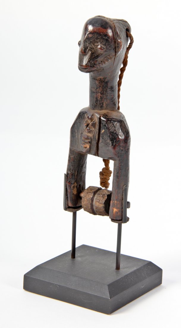 West African Narrow Strip Heddle on Stand: West African Narrow Strip Heddle, early 20th c, carved wood, patina. Size: 6" x 2" x 1" (figure). Provenance: Jane Steinsnyder.