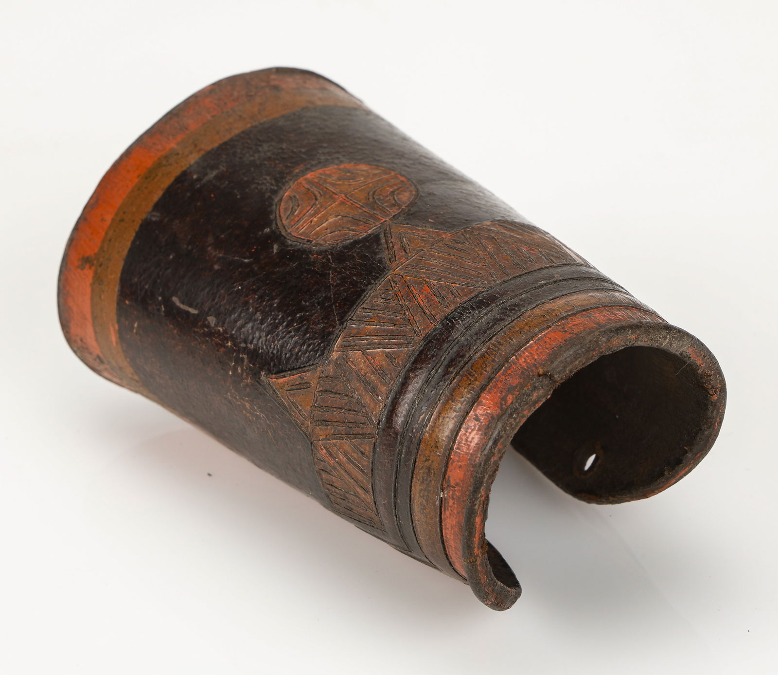 Antique Yi Armor Element, Arm Guard, China: Antique Yi Gauntlet, China. Leather with raised, embossed decorative work, yellow and black and red paint. Size: 4.5'' x 3'' x 3'' (11 x 8 x 8 cm). Provenance: Ex. Roger Hollander collection.