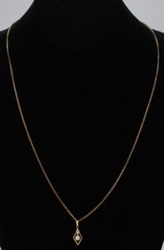 .750 Gold 22" Chain Necklace With a Charm