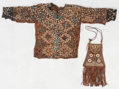 African Cowry Shell Embellished Woven Tunic and Tuareg Embossed Leather Bag (2): African Cowry Shell Embellished Woven Tunic and Tuareg Embossed Leather Bag (2). Woven plant fiber with beads, cowry shells, and hare fur; embossed leather. 5'0'' x 2'5'' (152 x 74 cm); 1'0'' x 1'0''