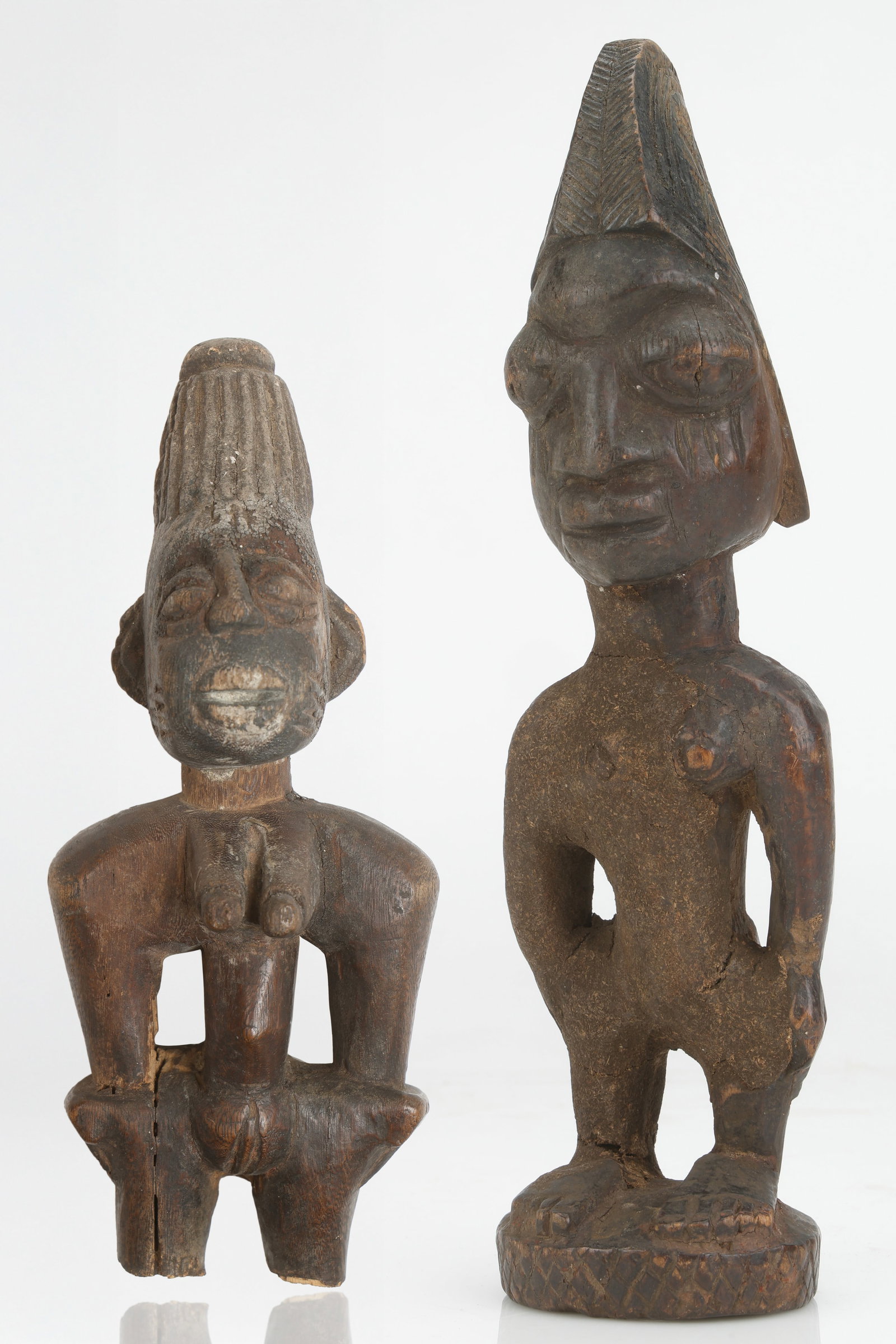 2 African Yoruba Ibeji Figures, Nigeria: 2 African Yoruba Ibeji Figures, Nigeria. carved wood. Size: 1) 12'' x 3.5'' x 3'' (30 x 9 x 8 cm). 2) 8'' x 3'' x 2'' (20 x 8 x 5 cm).