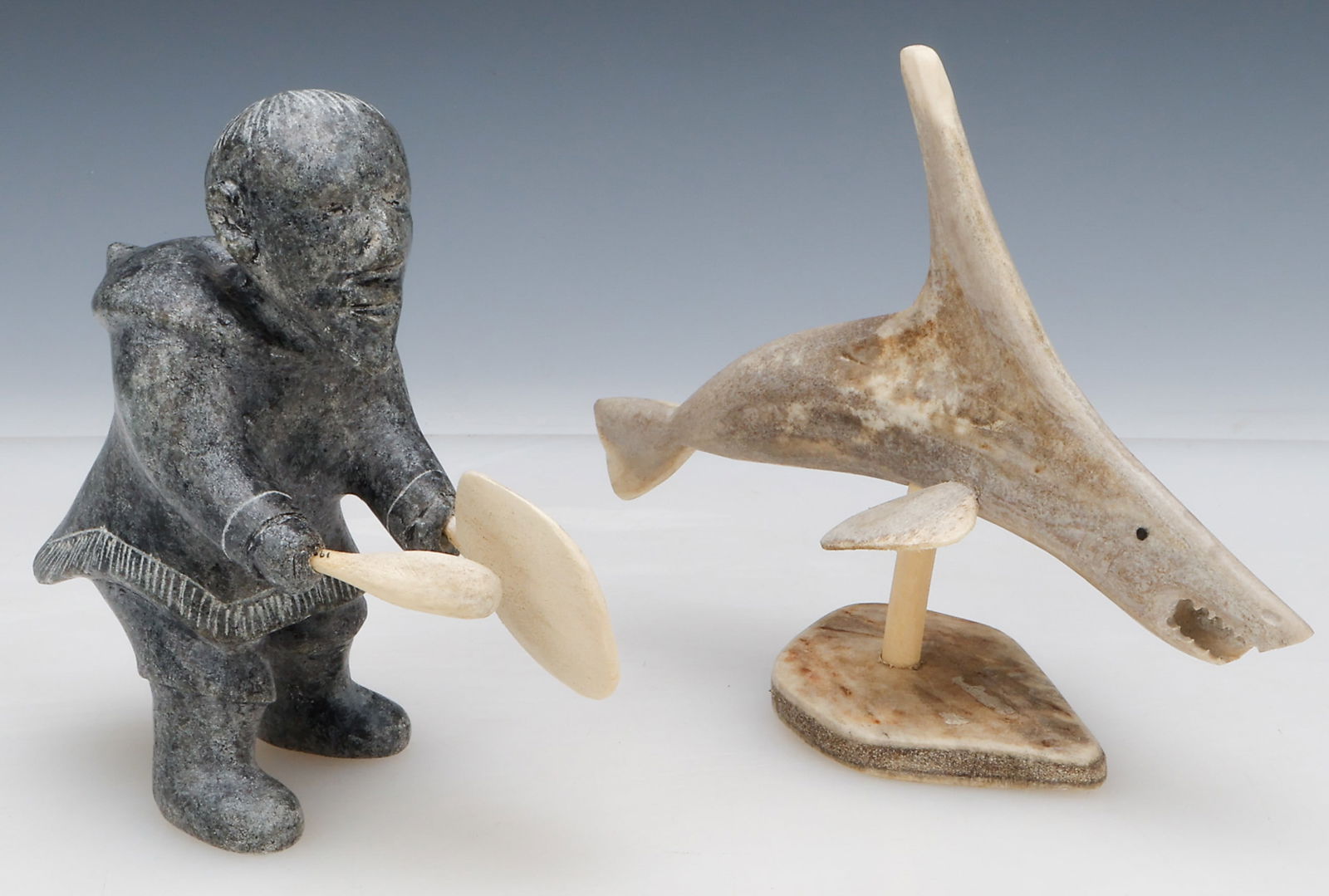 2 Inuit Carvings: 2 Inuit Carvings. 1) Edward Snowball (Inuit, b.1943) Whale Spirit, 1989, Caribou bone, antler. Size: 6'' x 7.5'' x 2.5'' (15 x 19 x 6 cm). 2) Iruku Nauja (Inuit, 20th C.) Drum Dancer, soapstone , cari
