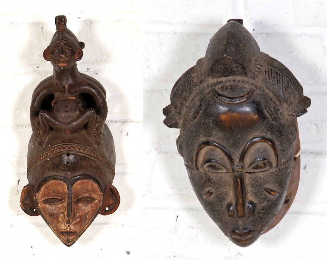 Two Vintage African Masks- One Earthenware the other Wo: Terra Cotta Mask. Size: 13.25" x 5.5" x 5" (34 x 14 x 13 cm). Carved Mask- Bun Hair. Size: 11" x 7" x 5" (28 x 18 x 13 cm). Provenance: Max Garb, Chicago, Illinois.