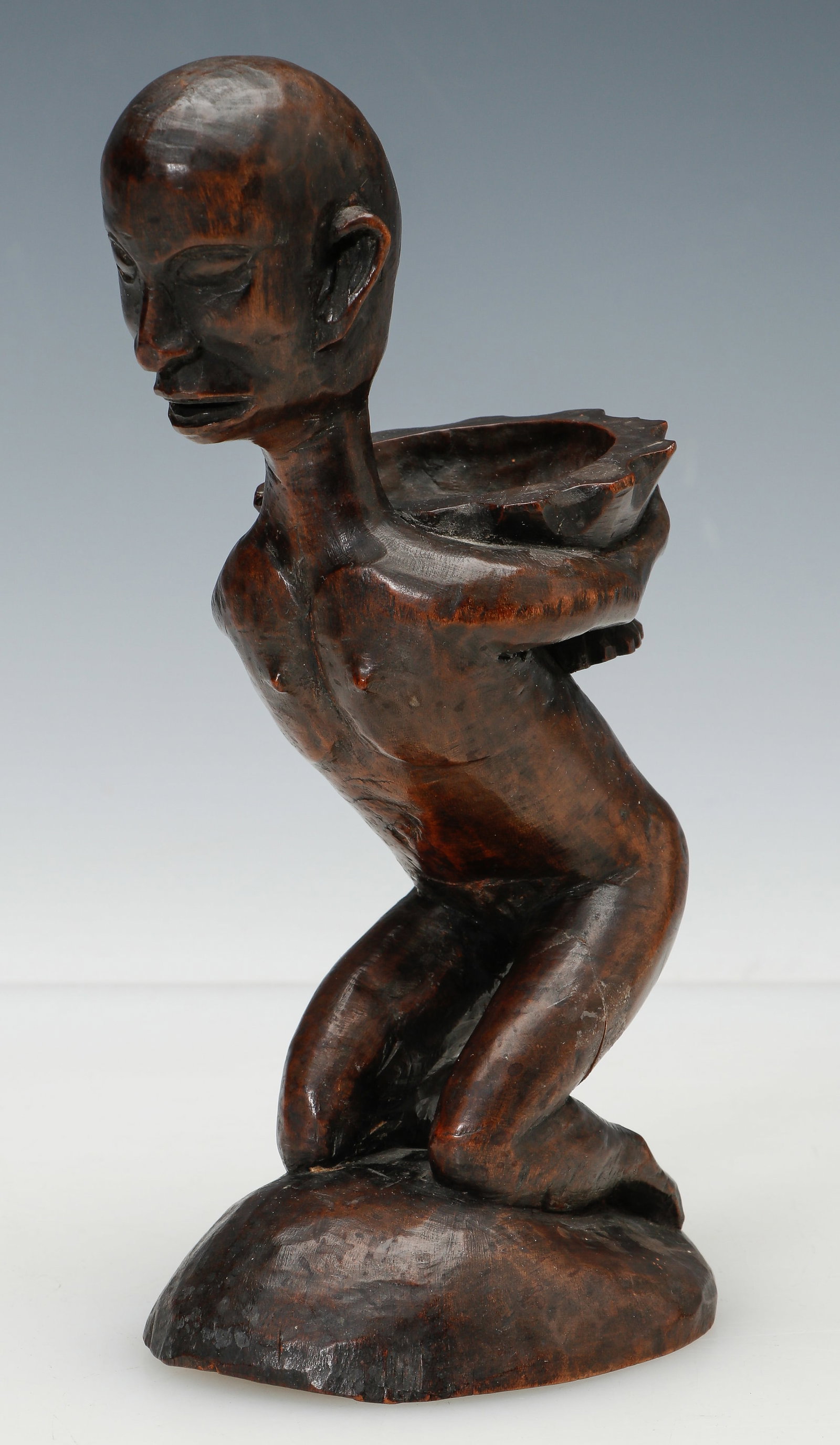 "Bowl Bearer" Sculpture, Ifugao, Northern Philippines, Pre War Colonial Era: "Bowl Bearer" Sculpture, Ifugao, Northern Philippines,Wood. Pre War Colonial Era. Carved for the curio market. Size: 8'' x 4'' x 3'' (20 x 10 x 8 cm).