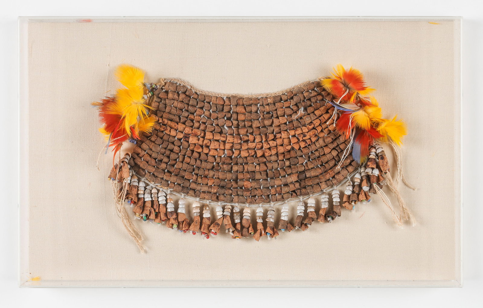 Amazonian Tribal Apron, Brazil: Amazonian Tribal Apron, Brazil. Plant fiber, plant beads, seeds. In plexiglass frame. Size: 7'' x 12'' (18 x 30 cm).