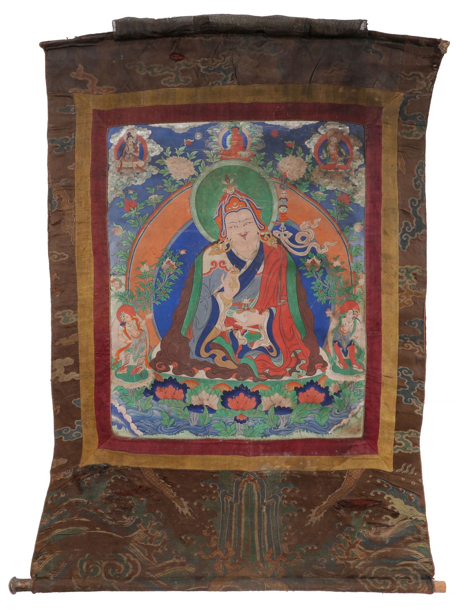 Antique Tibetan Thangka of Padmasambhava, also known as Guru Rinpoche: Antique Tibetan Thangka of Padmasambhava, also known as Guru Rinpoche . Paint on cloth with Chinese silk borders. Size: 22.5'' x 18.5'', 57 x 47 cm (sight); 40'' x 30'', 102 x 76 cm (overall). Provena