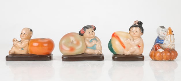 4 Painted White Chalk Figurines of Children with Oversized Fruits from The Great Leap Forward