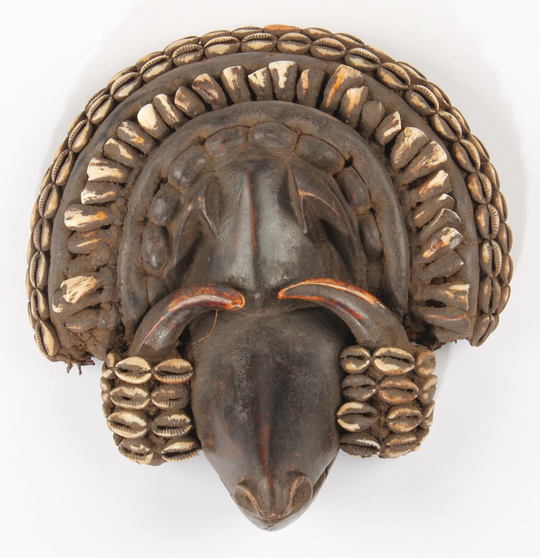 Zoomorphic Warthog Mask; Dan: Zoomorphic Warthog Mask; Dan Carved wood, cowrie shells, tusks, teeth and cloth. Size: 10" x 9.5" x 4" Provenance: Max Garb, Chicago, Illinois.