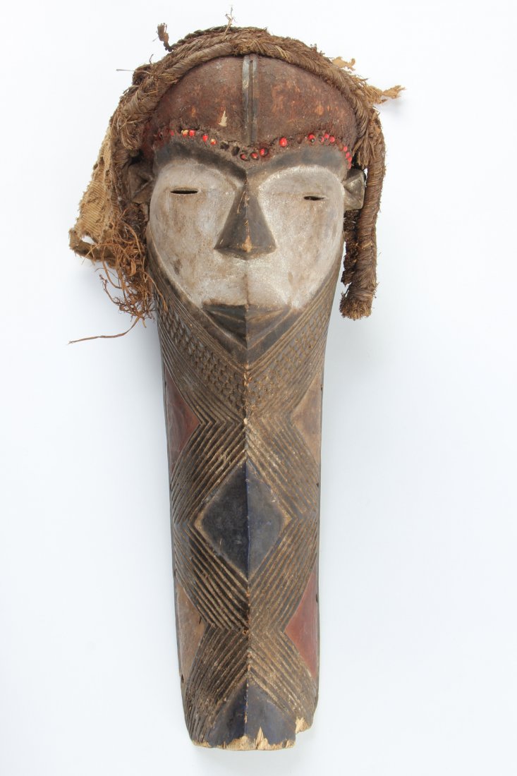 African Pende Muyombo Mask: Pende Muyombo Mask. Carved wood, kaolin paint, fiber and fabric. Size: 19" x 7" x 11". Provenance: Max Garb, Chicago, Illinois.