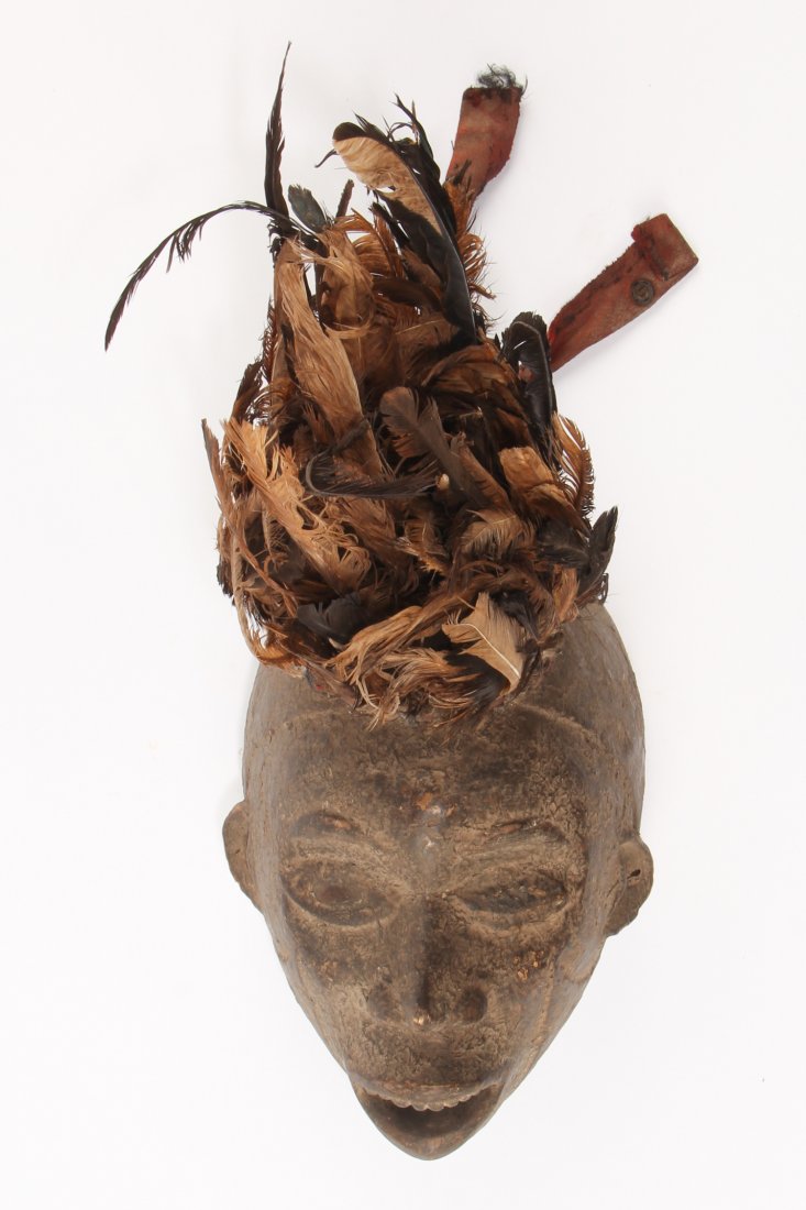 Plumed Kongo Mask: Plumed Kongo Mask. Carved wood, feathers, fabric and glass eyes. Size: 17" x 7" x 12" Provenance: Max Garb, Chicago, Illinois.