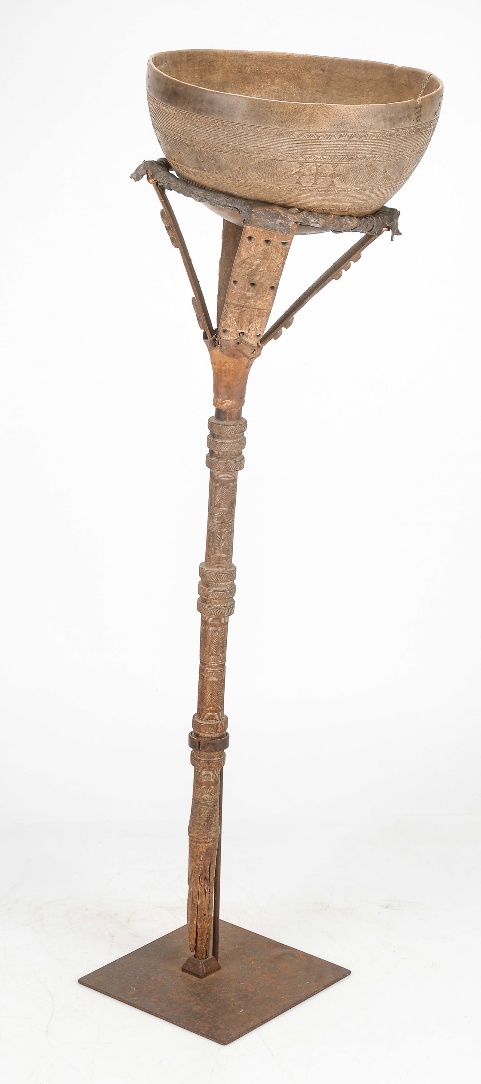 African Tuareg Bowl And Stand: African Tuareg Bowl And Stand. Carved wood and leather. Tuareg bowls of this type are skeumorphs. They are carved from wood in the form of hemispherical gourds and then incised with symmetrical design