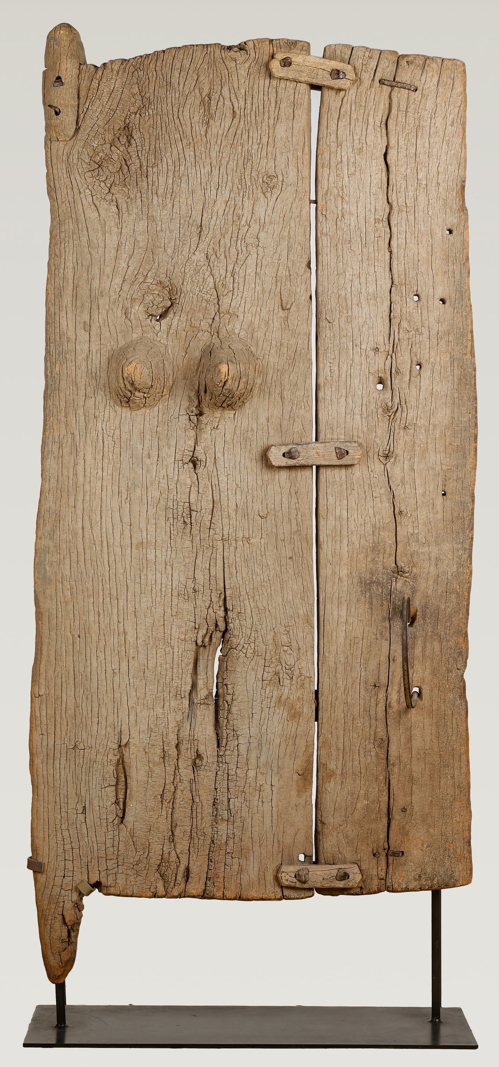 African Dogon Anthropomorphic Door, Mali, HOS: 71": African Dogon Anthropomorphic Door, Mali. Carved wood with metal fastenings. On stand. Size: 67'' x 31'' x 6'' (170 x 79 x 15 cm); Height On Stand: 71" (180 cm). Provenance: Property from the Estate o