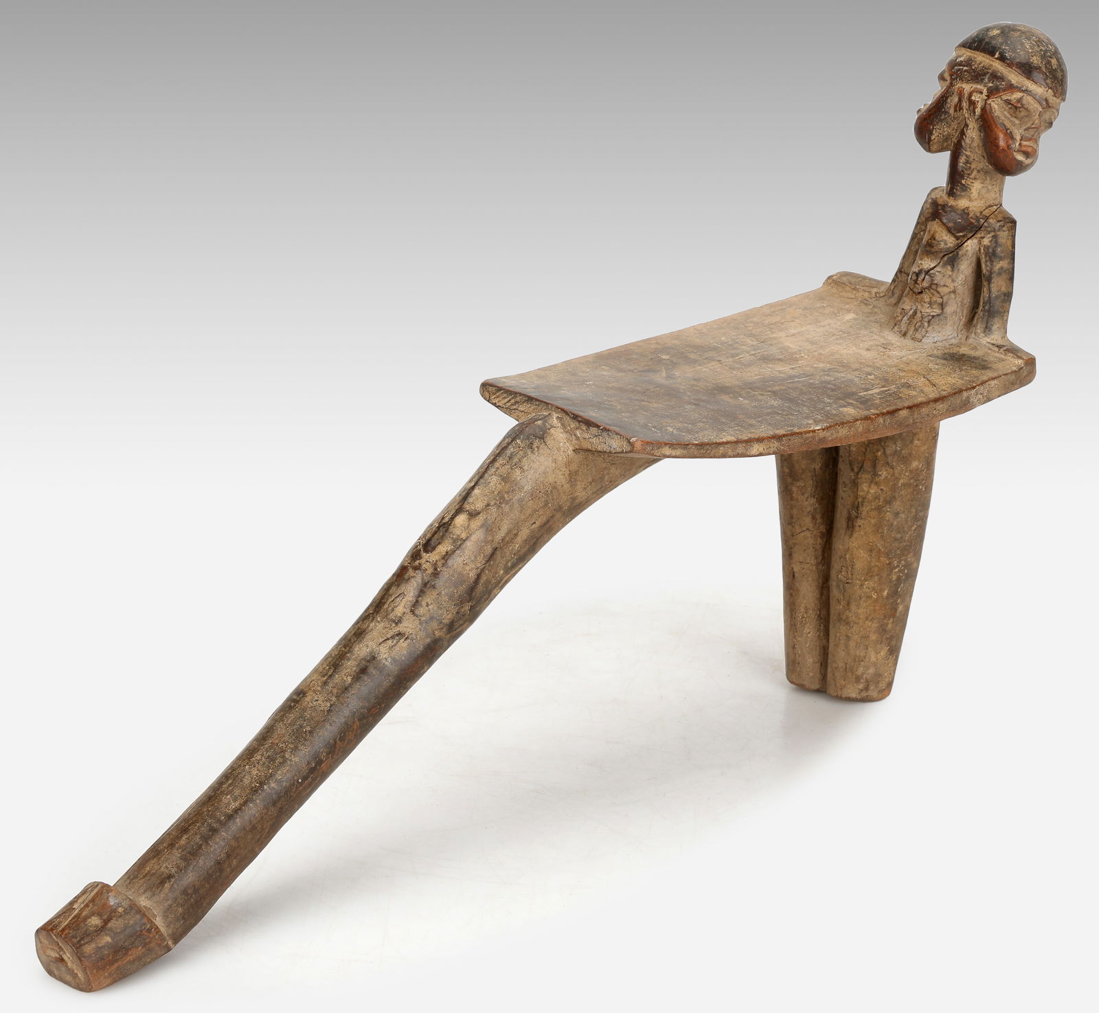 Lobi Stool, Burkina Faso: Lobi Stool, Burkina Faso. Torso with Janiform face at top. Size: 10.5'' x 18.5'' x 4.5'' (27 x 47 x 11 cm). Provenance: ex Michelle Gilbert Trust.