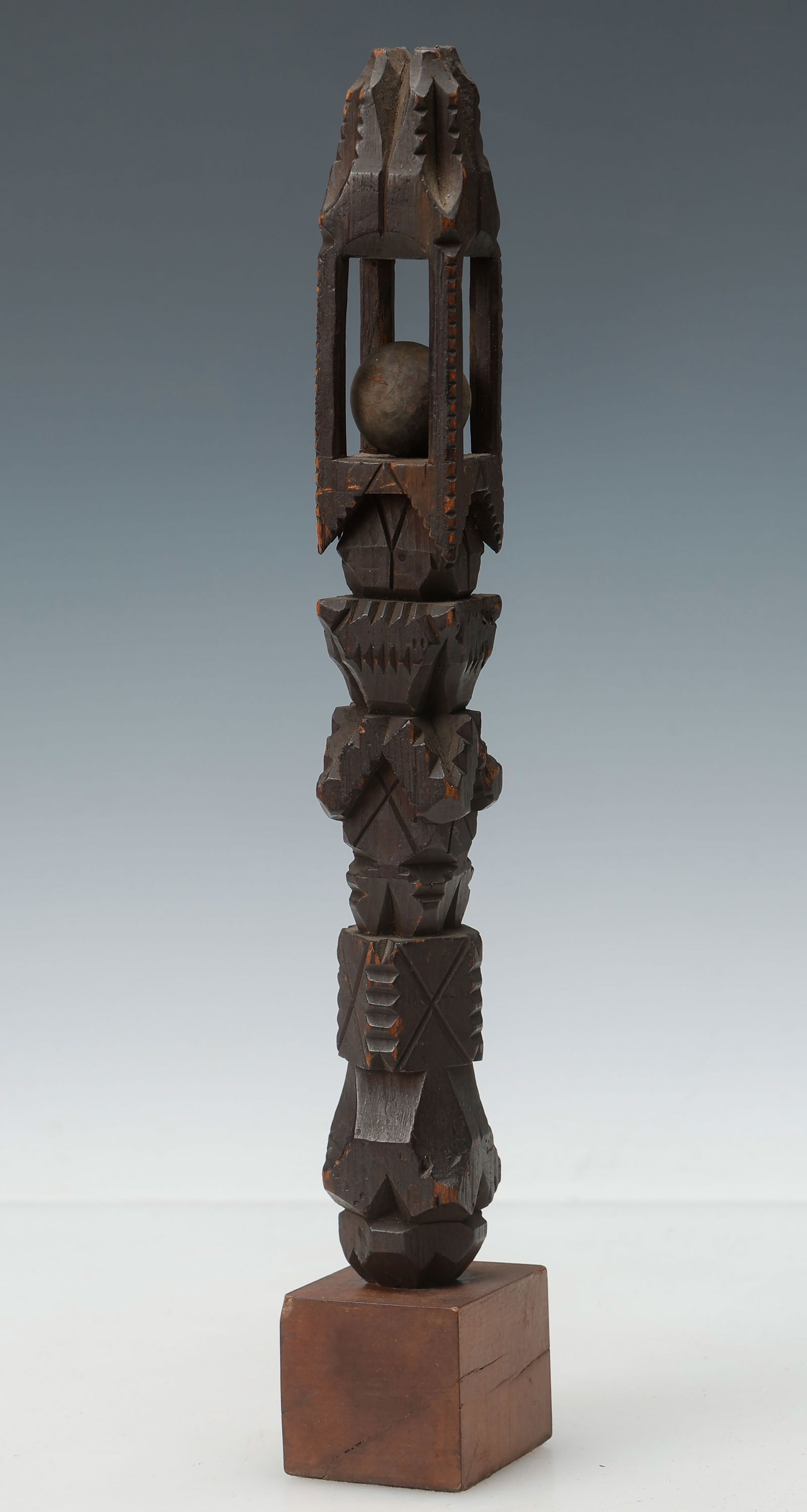African Carved Wood Totem-Form Rattle: African Carved Wood Totem-Form Rattle, incised geometric designs. On stand. Size: 11.5'' x 1.5'' x 1.5'' (29 x 4 x 4 cm). Provenance: Neal Auctions, Lot 418, March 10, 2022; Estate of New Orleans Muse