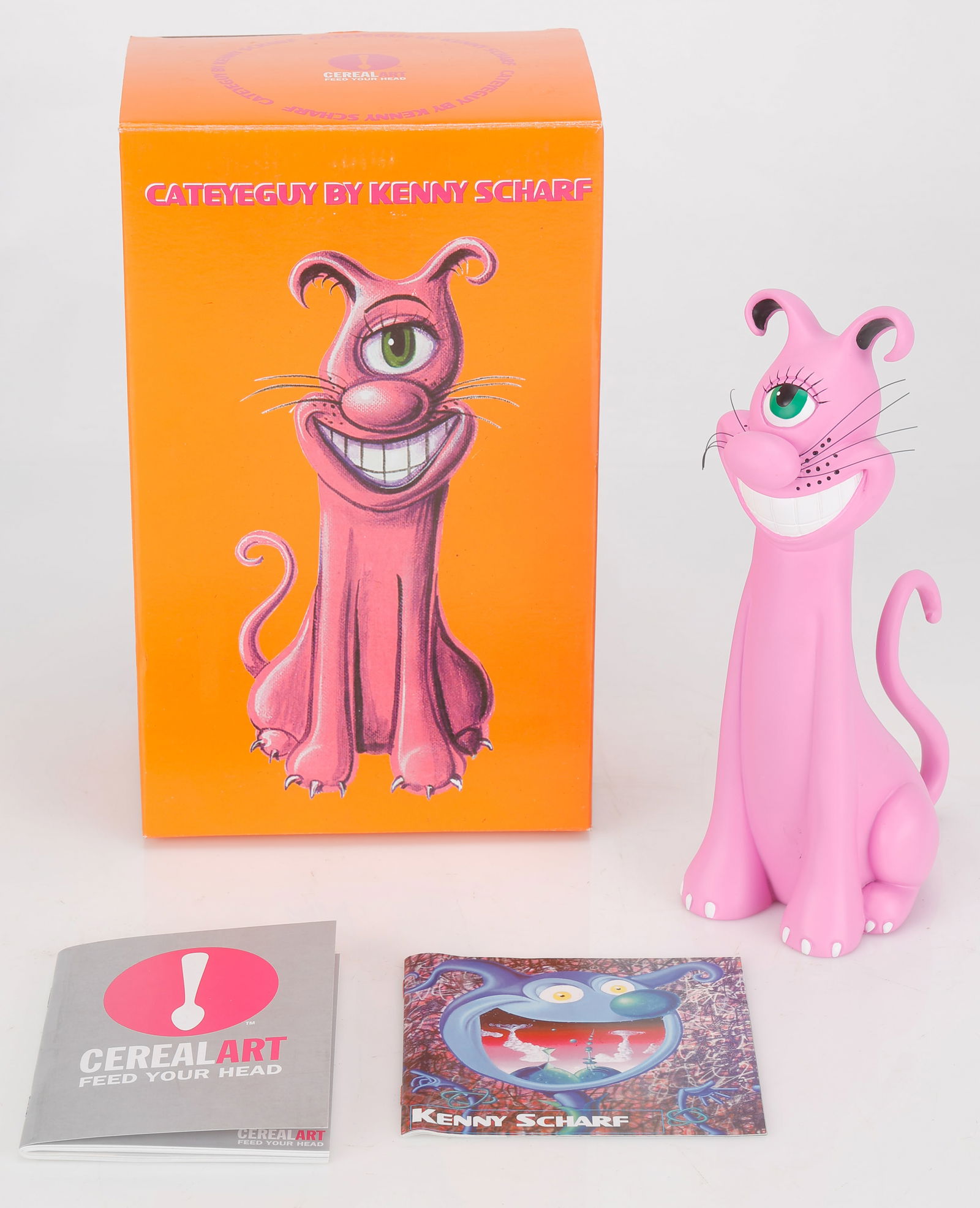 Kenny Scharf (American, b. 1958) "Cateyeguy," 2004: Kenny Scharf (American, b. 1958) "Cateyeguy," 2004, painted resin cat sculpture, in original box. Limited edition of 2500 in collaboration with Cereal Art. Stamped signature at the bottom. Size: 10''