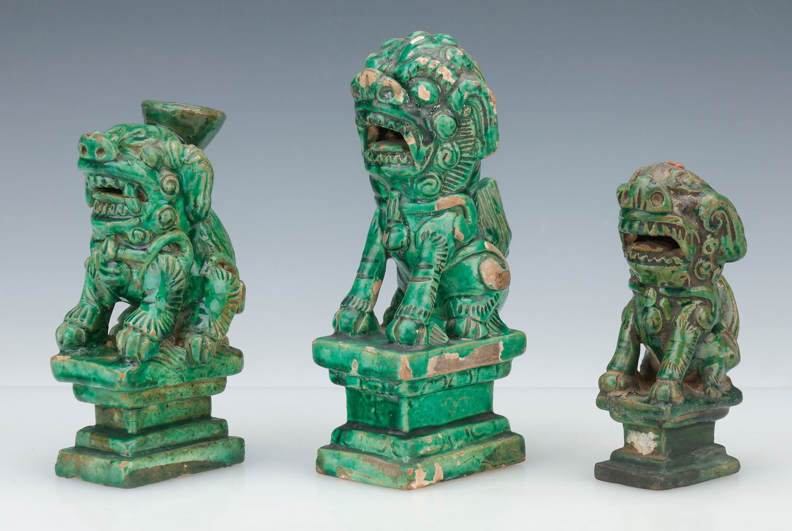 3 Chinese Green Glazed Pottery Foo Dogs: 3 Chinese Green Glazed Pottery Foo Dogs. Sizes Ranging From: 6'' x 3'' x 2.5'' (15 x 8 x 6 cm); To: 8'' x 4'' x 2.5'' (20 x 10 x 6 cm). Provenance: Private Philadelphia Estate Collection.