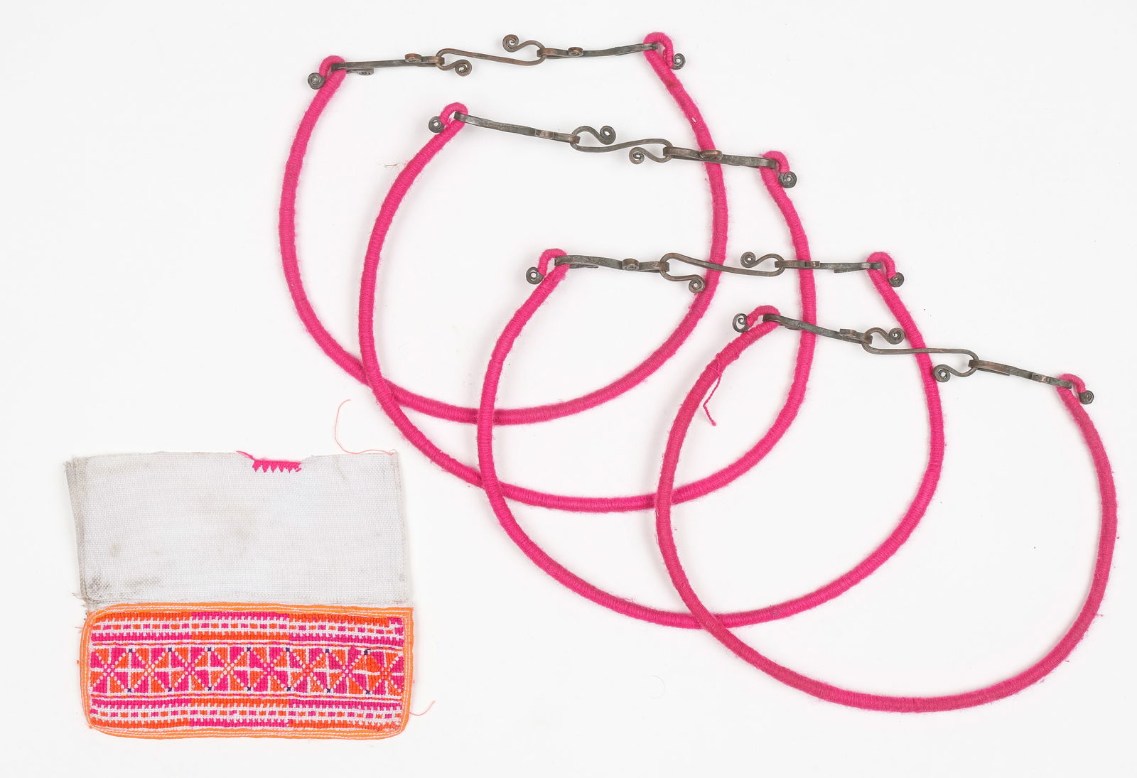 Antique Torques, China: Antique Torques, China. Copper wire wrapped in pink cotton thread and joined at the back with a cotton cloth element wrapped around the raw wire. The cloth section is embroidered with silk. Each Size: