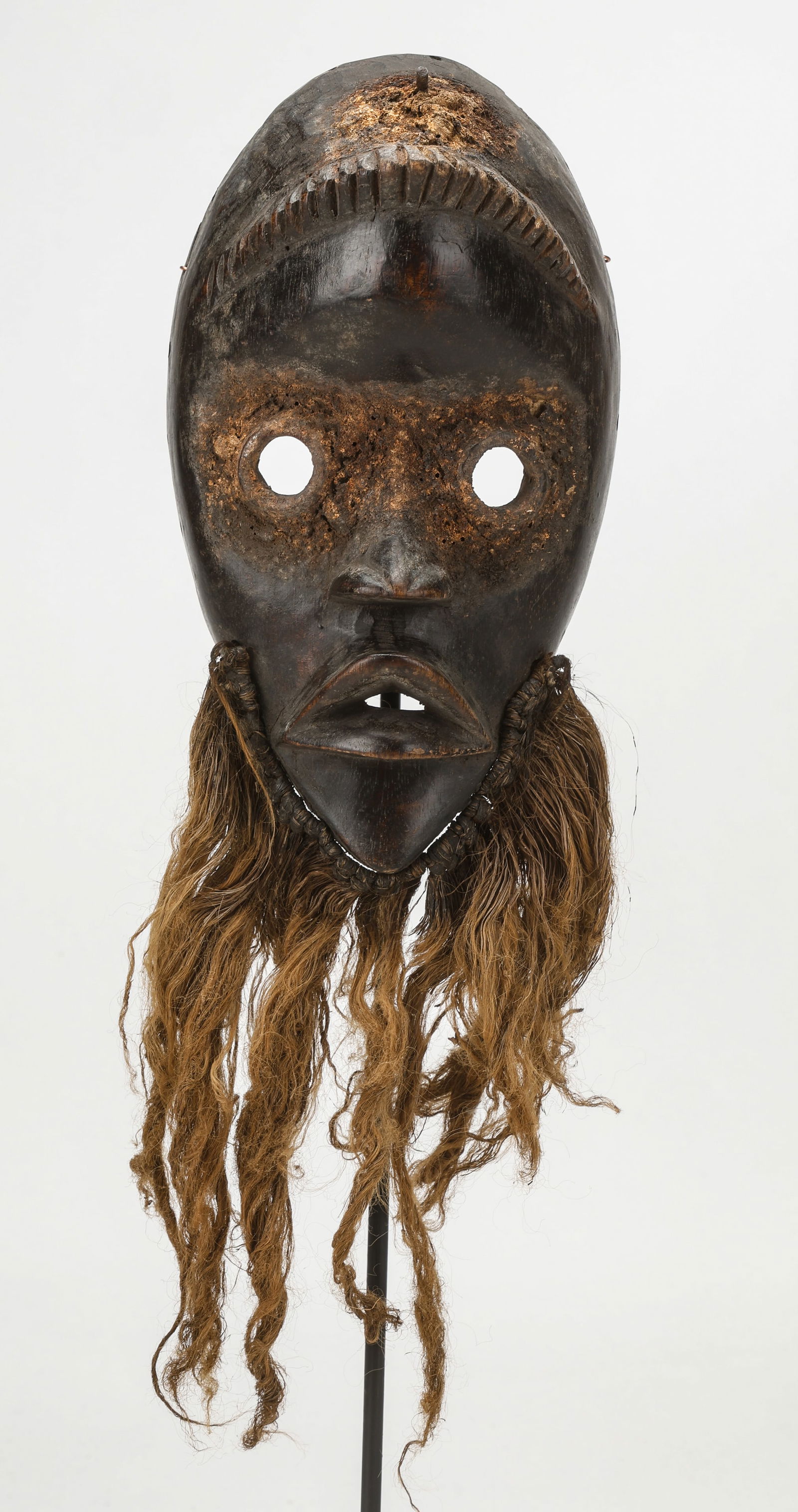 African Dan Zakpie Ge Mask, Ivory Coast/Liberia: African Dan Zakpie Ge Mask, Ivory Coast/Liberia. Used to prevent village fires. Carved wood, fiber beard, sacrificial offering remains on head and around eyes. Size: 9.25'' x 5'' x 3'' (23 x 13 x 8 cm