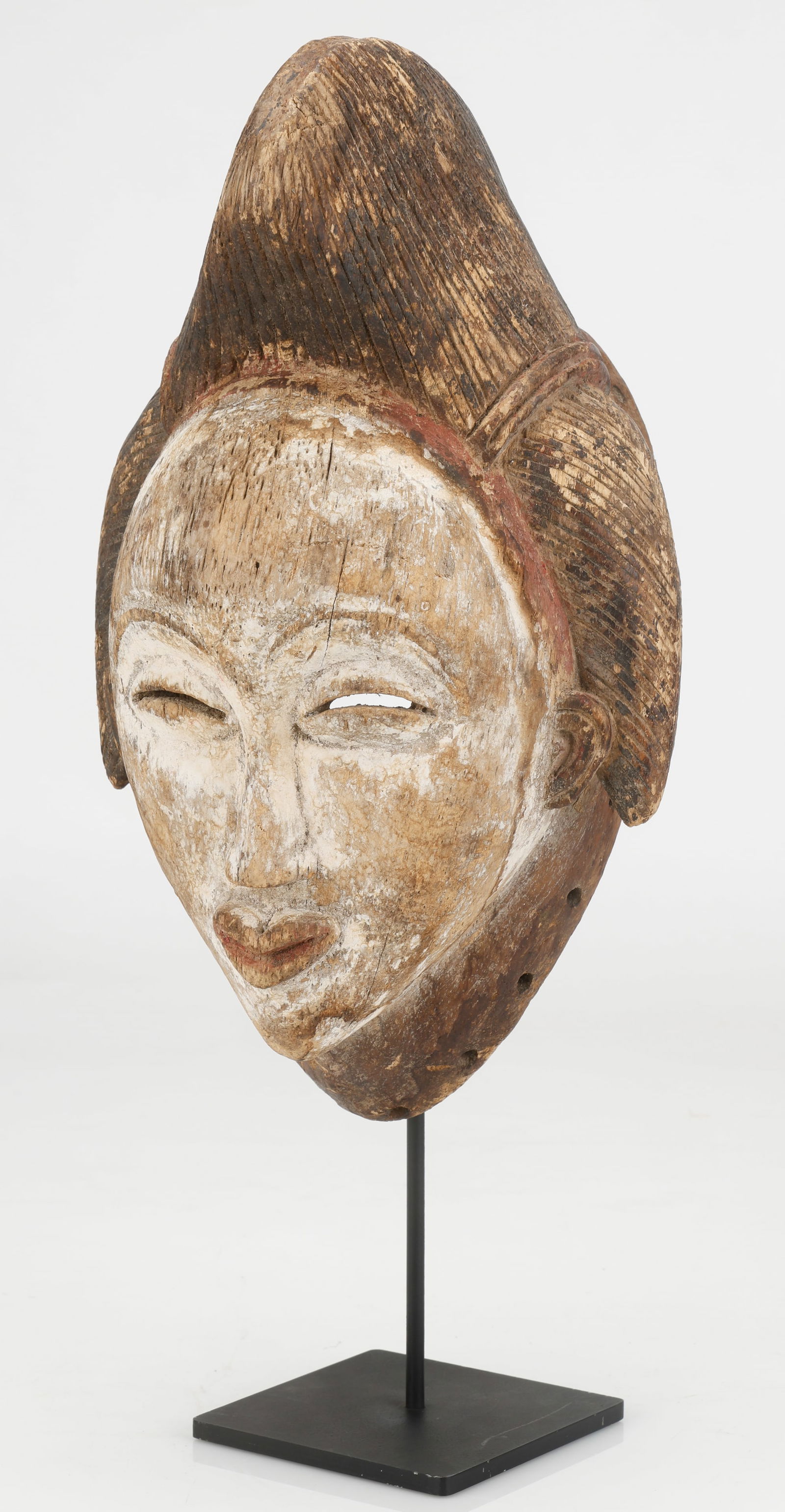 African Punu Mask, Gabon: African Punu Mask, Gabon. Carved wood and pigment. Stand not included. Size: 14'' x 8'' x 6'' (36 x 20 x 15 cm).