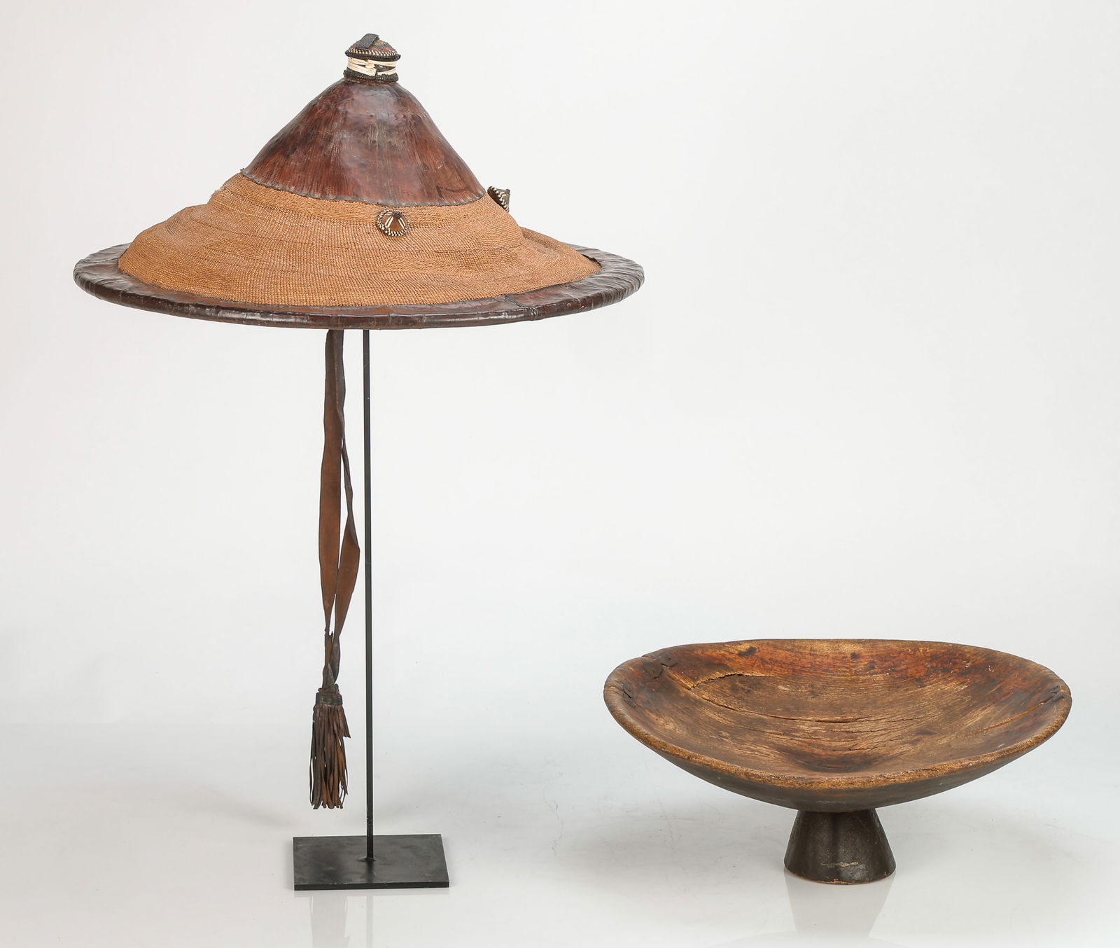 African Collector's Lot: African Collector's Lot. Including: 1) West African Fulani Wodaabe Hat, Mali. Plant fiber, leather. Diameter: 22" (56 cm). 2) Moroccan Wood Footed Bowl. Size: 7.75'' x 18.5'' x 18.5'' (20 x 47 x 47 cm