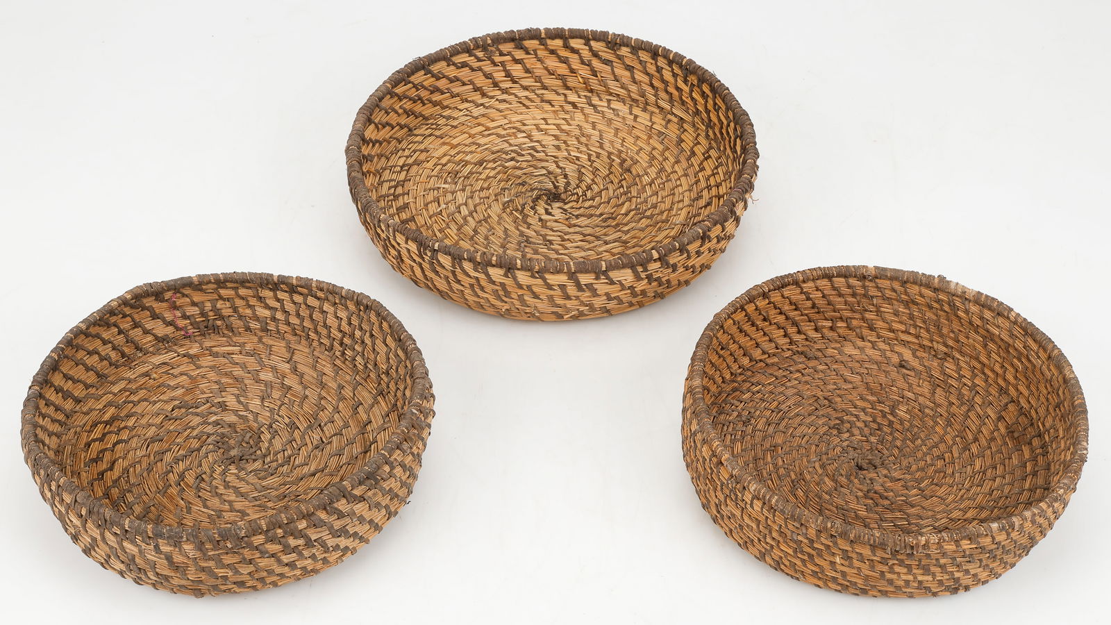3 Chipaya Baskets, Sabaya Province, Department of Oruro, Bolivia: 3 Chipaya Baskets, Sabaya Province, Department of Oruro, Bolivia. Hand woven in a circular coiling technique of local aquatic rushes and leather strips. Early 20th Century. Sizes From: 3'' x 10'' x 10