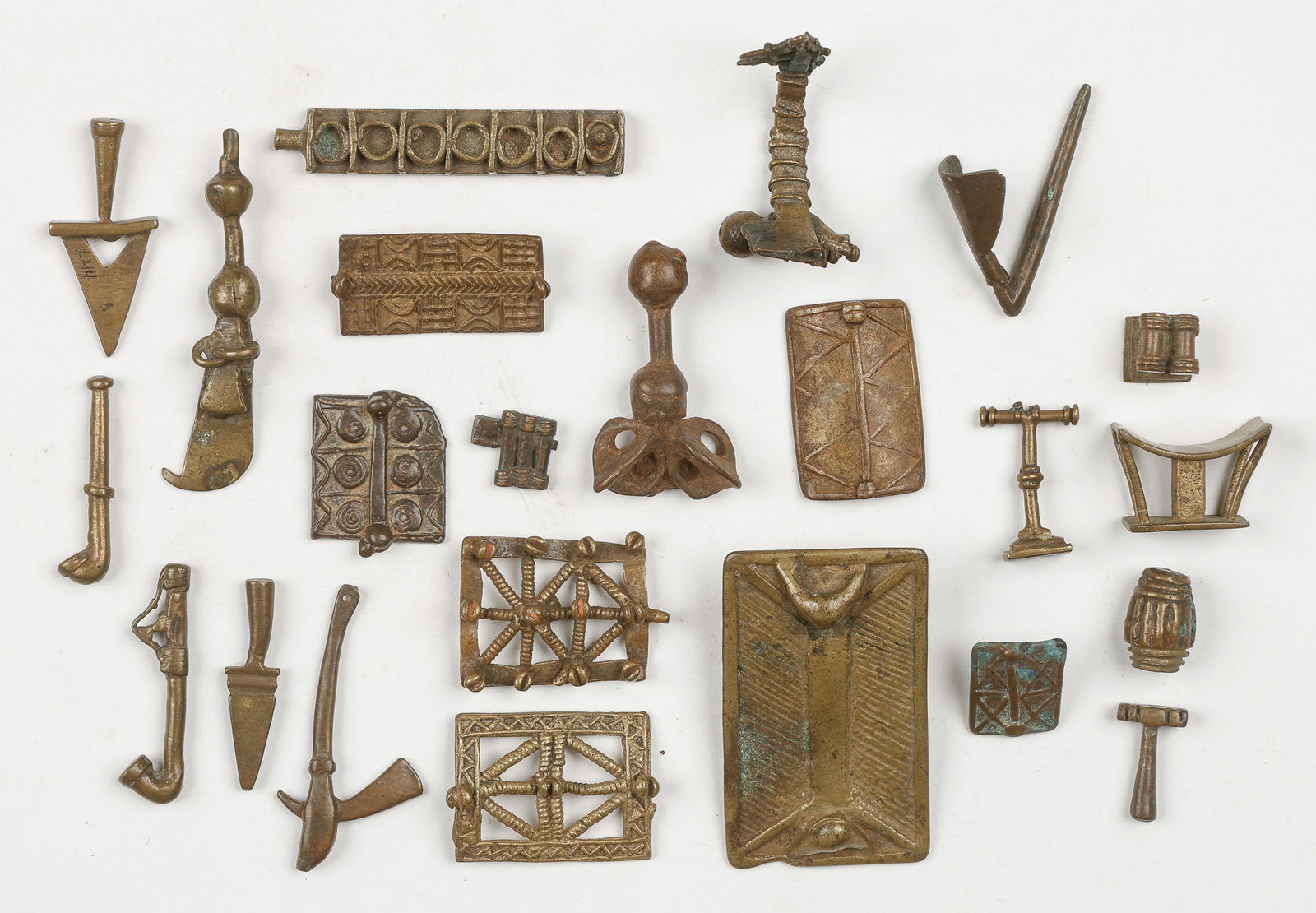 23 Akan Cast Brass Gold Weights, Ghana: 23 Akan Cast Brass Gold Weights, Ghana. Sizes From: .25'' x .25'' (1 x 1 cm); To: 1.5'' x 2.5'' (4 x 6 cm). Provenance: From the Collection of Richard Kempshall Meyer.
