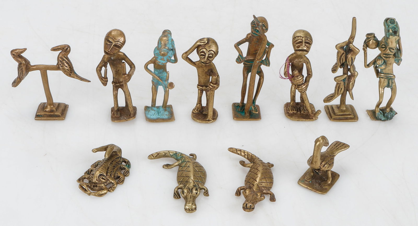 12 Akan Cast Brass Gold Weights, Ghana: 12 Akan Cast Brass Gold Weights, Ghana. Including human figures, birds, crocodiles, scorpion. Sizes From: 1.5" (3 cm); To: 3" (8 cm). Provenance: From the Collection of Richard Kempshall Meyer.