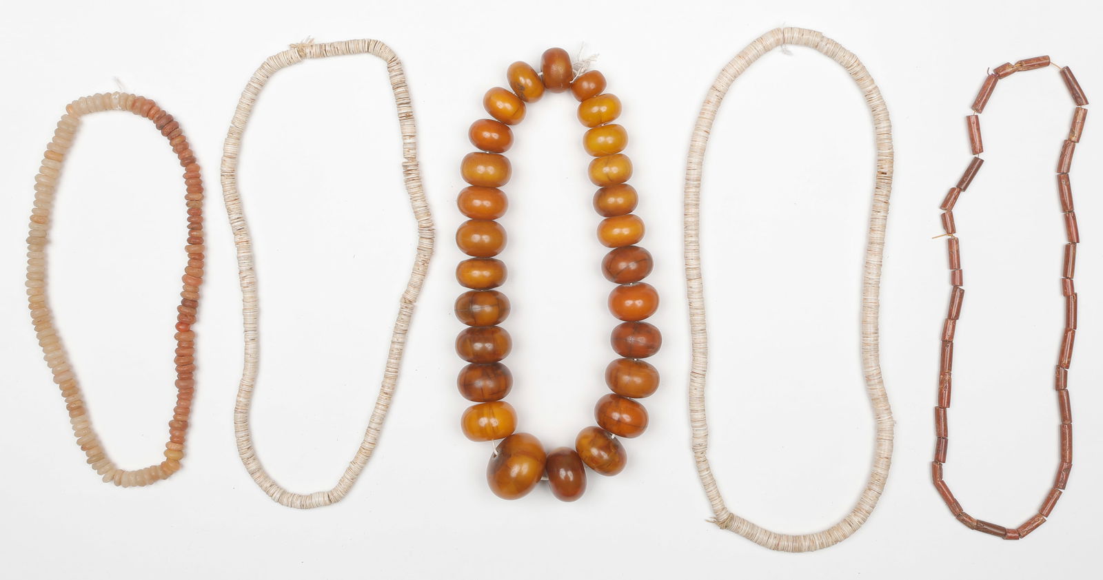 5 African Shell And Amber Bead Necklaces: 5 African Shell And Amber Bead Necklaces. Lengths From: 12" (30 cm); To: 16" (41 cm). Provenance: From the Collection of Richard Kempshall Meyer.