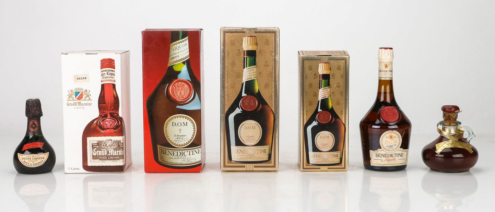 Seven Assorted Bottles of Liqueur: Seven Assorted Bottles of Liqueur. Including: Petite Liqueur (Moet and Chandon), Liqueur De Framboise (Concillon and Fils), Grand Marnier (Orange Liqueur) (with box) and, Benedictine D.O.M. (Varying S
