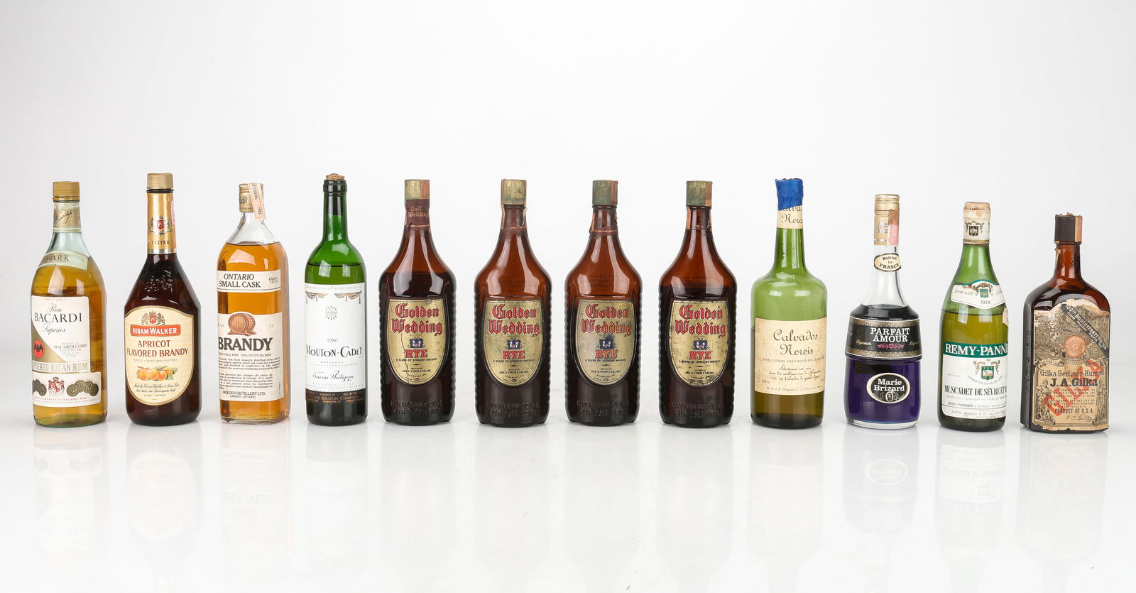 Twelve Various Bottles of Alcohol: Twelve Various Bottles of Alcohol (Some possibly opened, ullage). Including: Marie Brizard (Parfait Amour), Baron Philippe (Mouton-Cadet), Golden Wedding (Rye) x4, J.A. Gilka (Kummel Liqueur), Remy-Pa