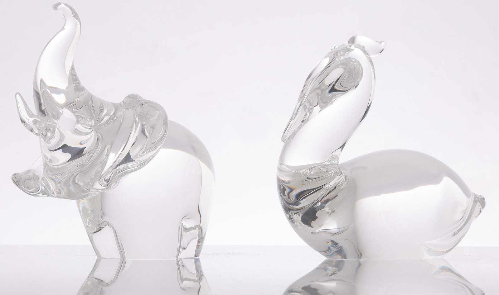 Steuben Glass Elephant and Pelican: Steuben Glass Elephant and Pelican, Signed. Sizes: 1) 6'' x 6'' x 4.5'' (15 x 15 x 11 cm); 2) 6'' x 7'' x 3'' (15 x 18 x 8 cm).