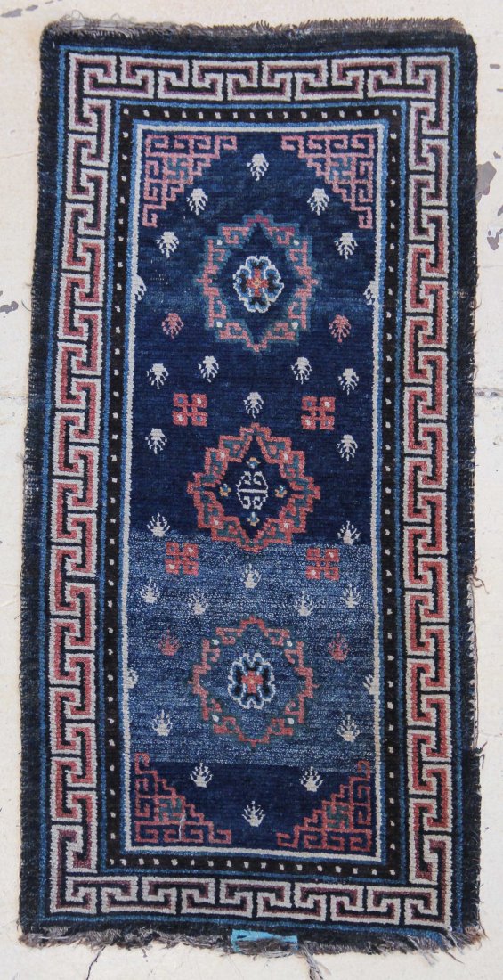 Tibetan Khaden Rug: Tibetan khaden sleeping carpet - blue abrash field 3 central asian inspired medallions and 'frog foot' motif with T meander border. Mid 19th c. Size: 4'10" x 2'4" (147 x 71 cm). Provenance: Bill Liske