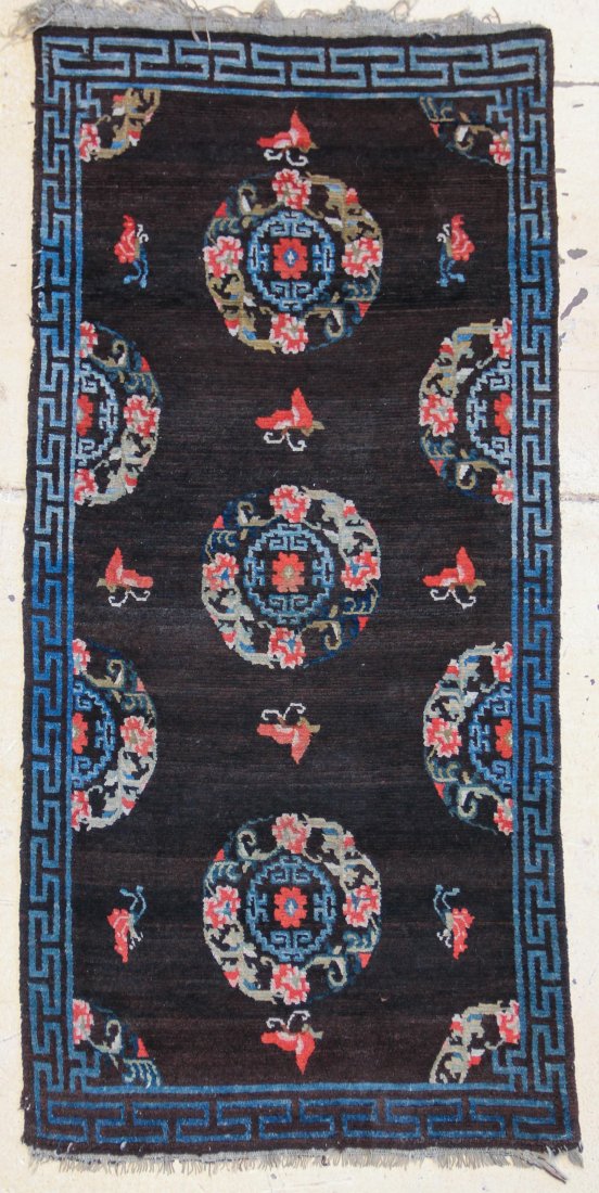 Tibetan Khaden Rug: Tibetan khaden sleeping carpet - rare brown field with multi-colored floral brocade/coin design with bats/butterflies. Last quarter 19th c./first quarter 20th c. Size: 5'10" x 2'9" (177 x 83). Provena