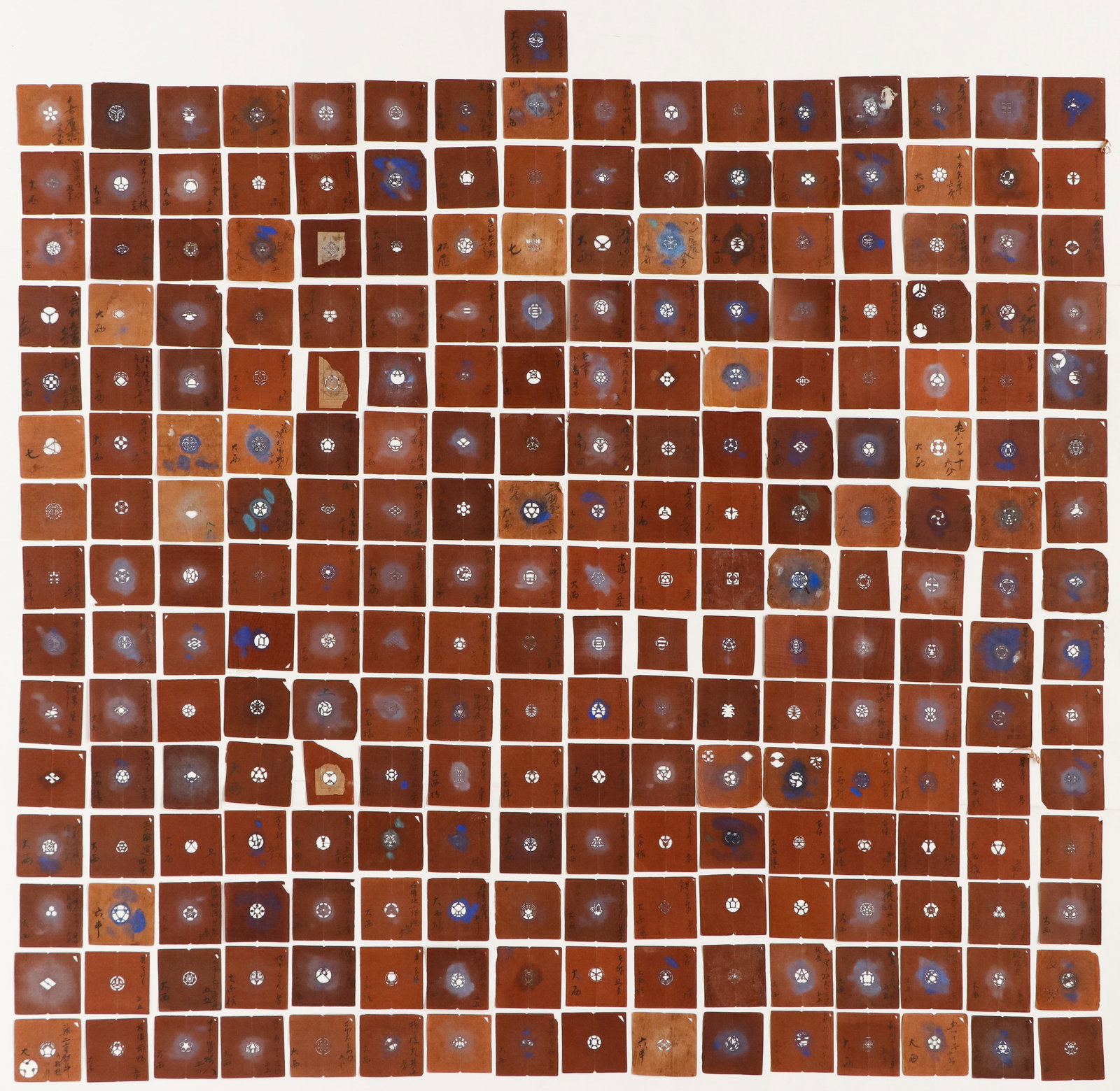 241 Small Japanese Mon Family Crest Stencils, Each approx.: 3.5" x 3.5": 241 Small Japanese Mon Family Crest Stencils. Brown paper stencils, each with a central emblem. many show use through blue ink stains, and many have calligraphy labels. Mon is a term for any kind of e