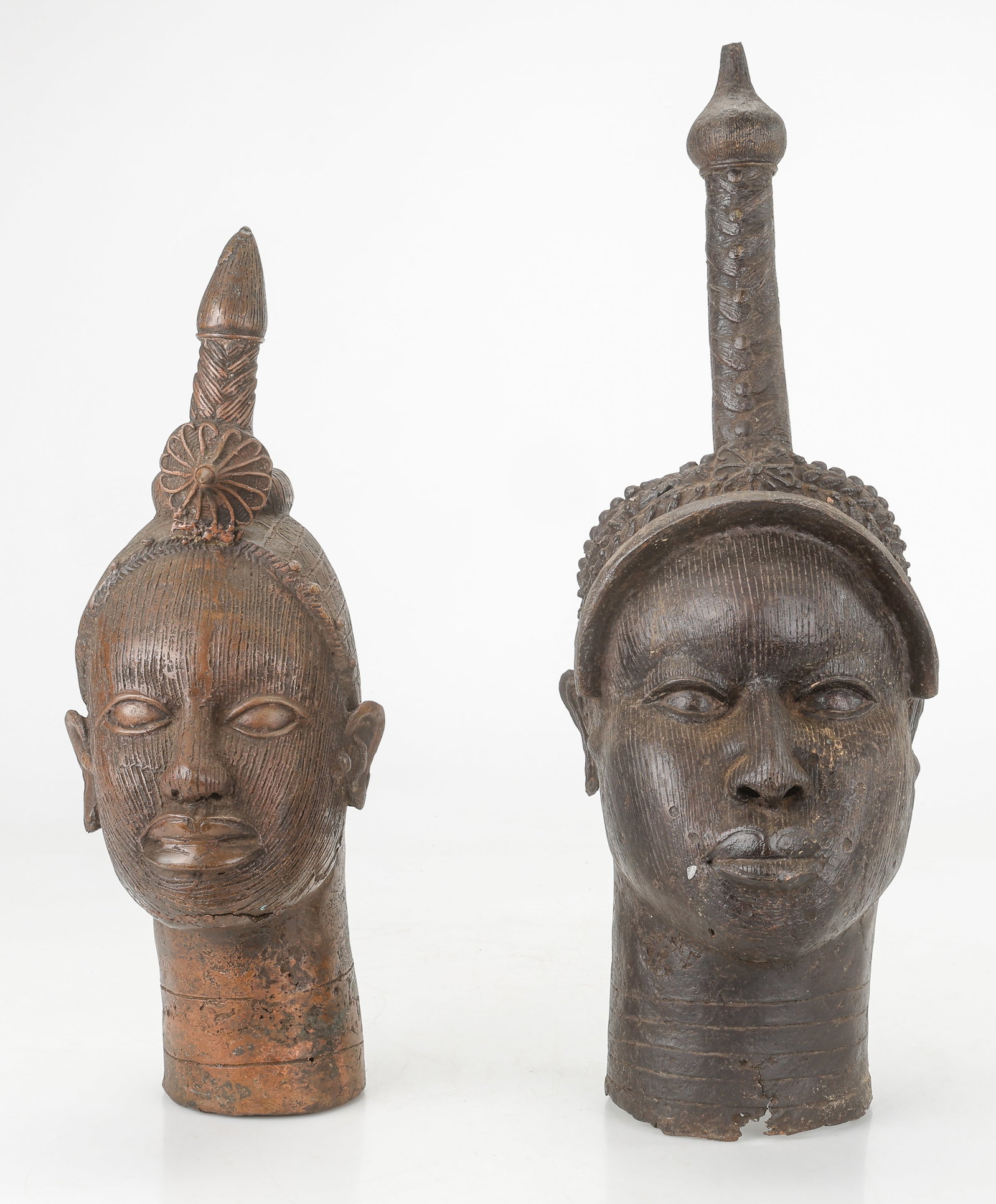 2 Benin Bronze Female Heads, Queen Mother Type, 22", 27": 2 Benin Bronze Heads Of A Woman, Queen Mother type. Sizes: 1) 22'' x 7'' x 8'' (56 x 18 x 20 cm); 2) 27'' x 9'' x 10'' (69 x 23 x 25 cm). Total weight: 39.5 lbs. Provenance: Collection of Charles L. B